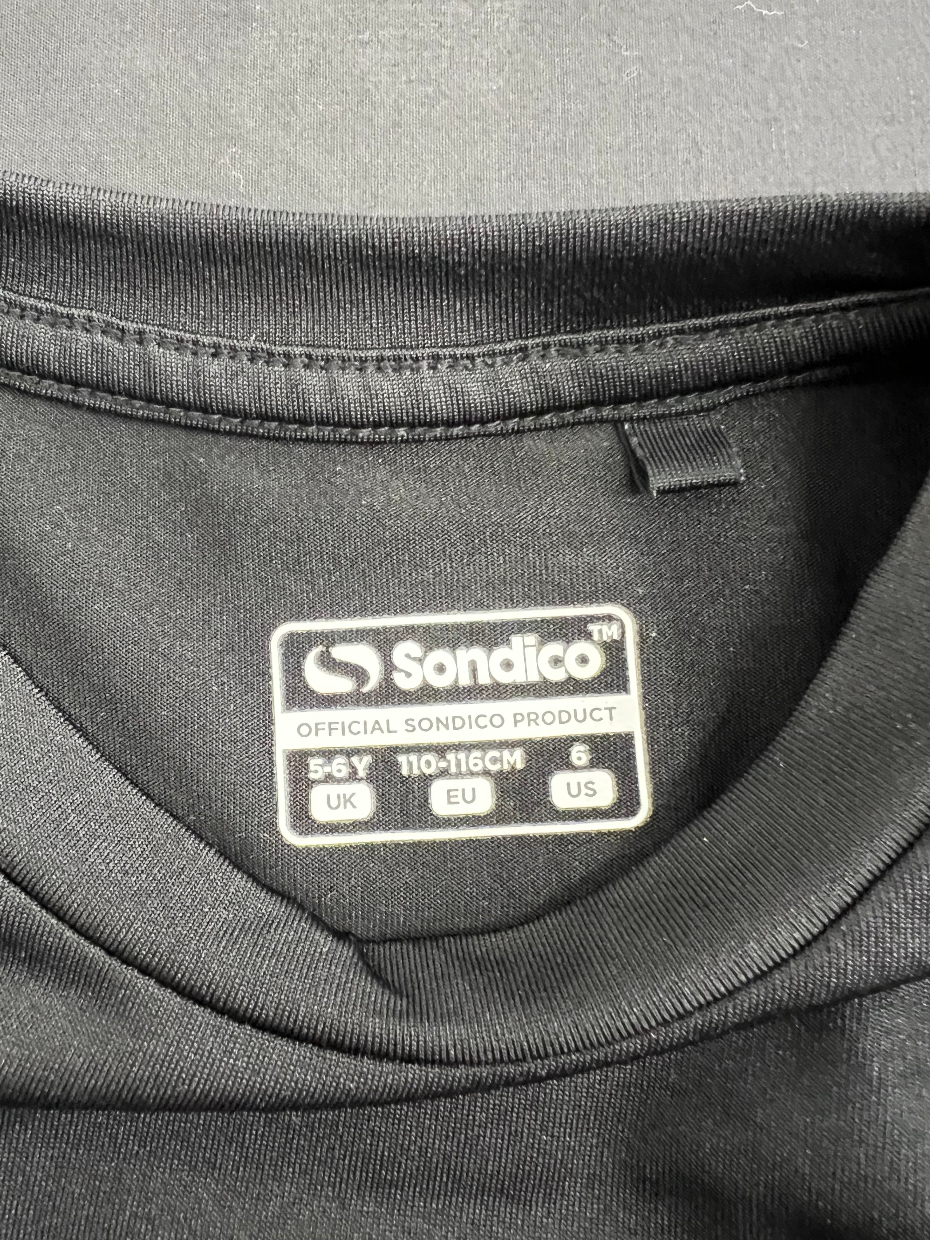 Close-up image of Sondico product label inside black kids base layer size 5-6 years