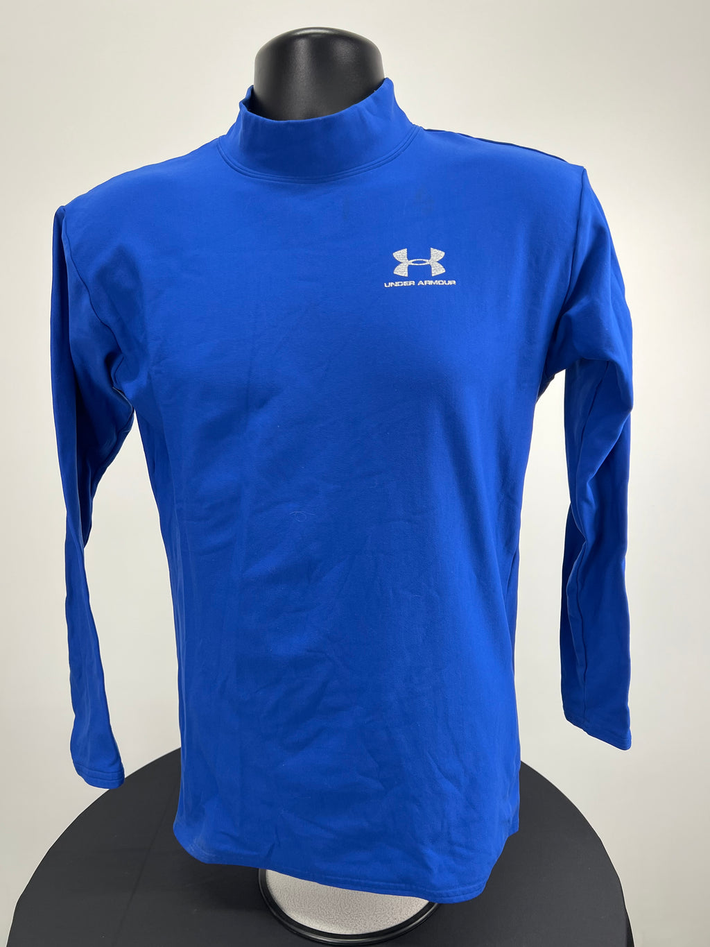 Front view of blue Under Armour thick base layer top with white logo on chest