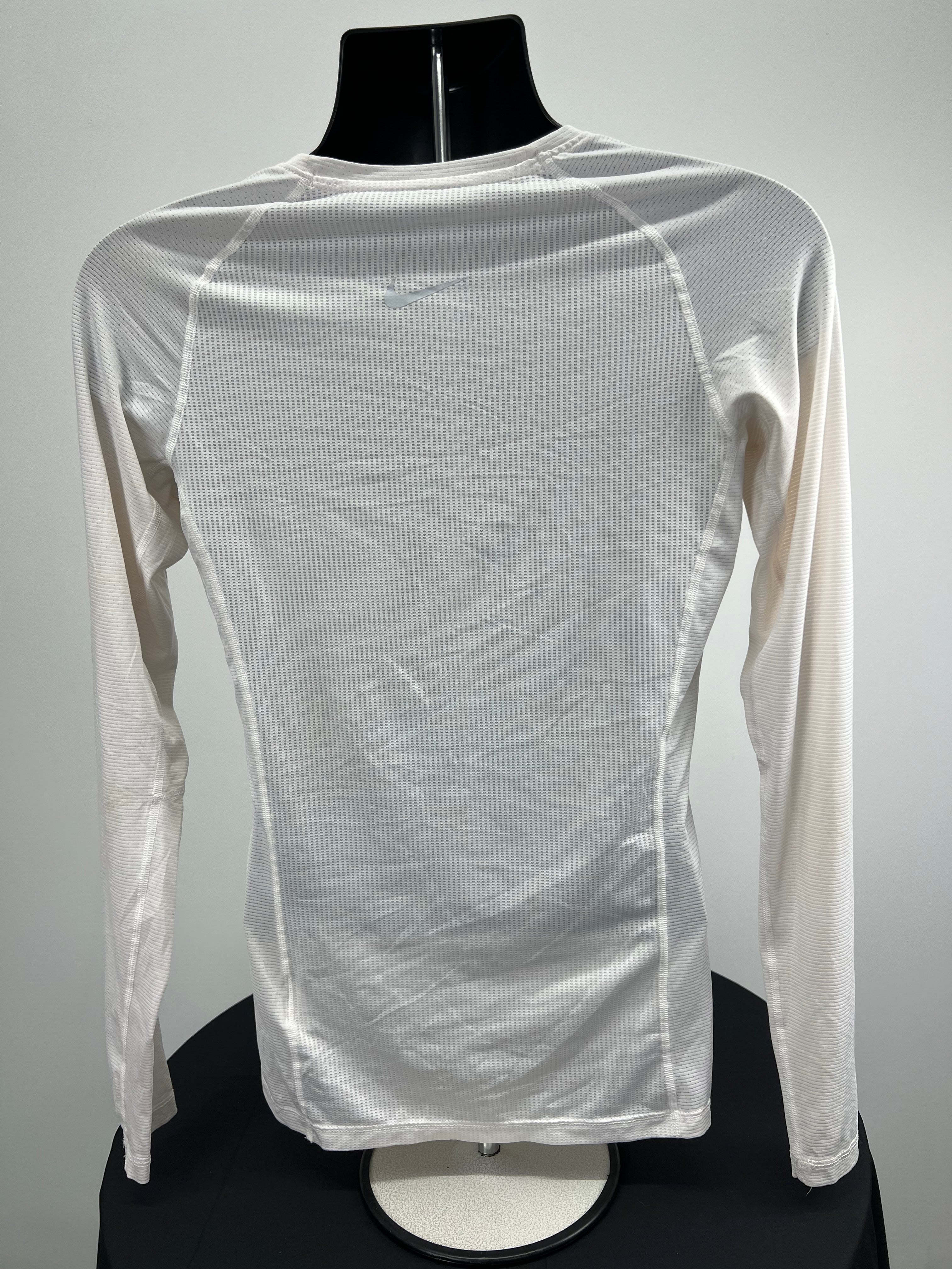 Back view of women's cream Nike Pro long sleeve top showing mesh fabric and Nike swoosh logo