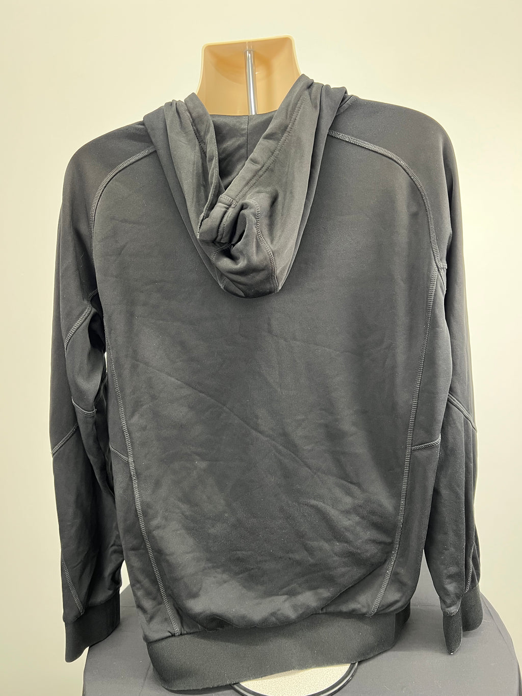 Rear view of black hoodie showing hood and plain back