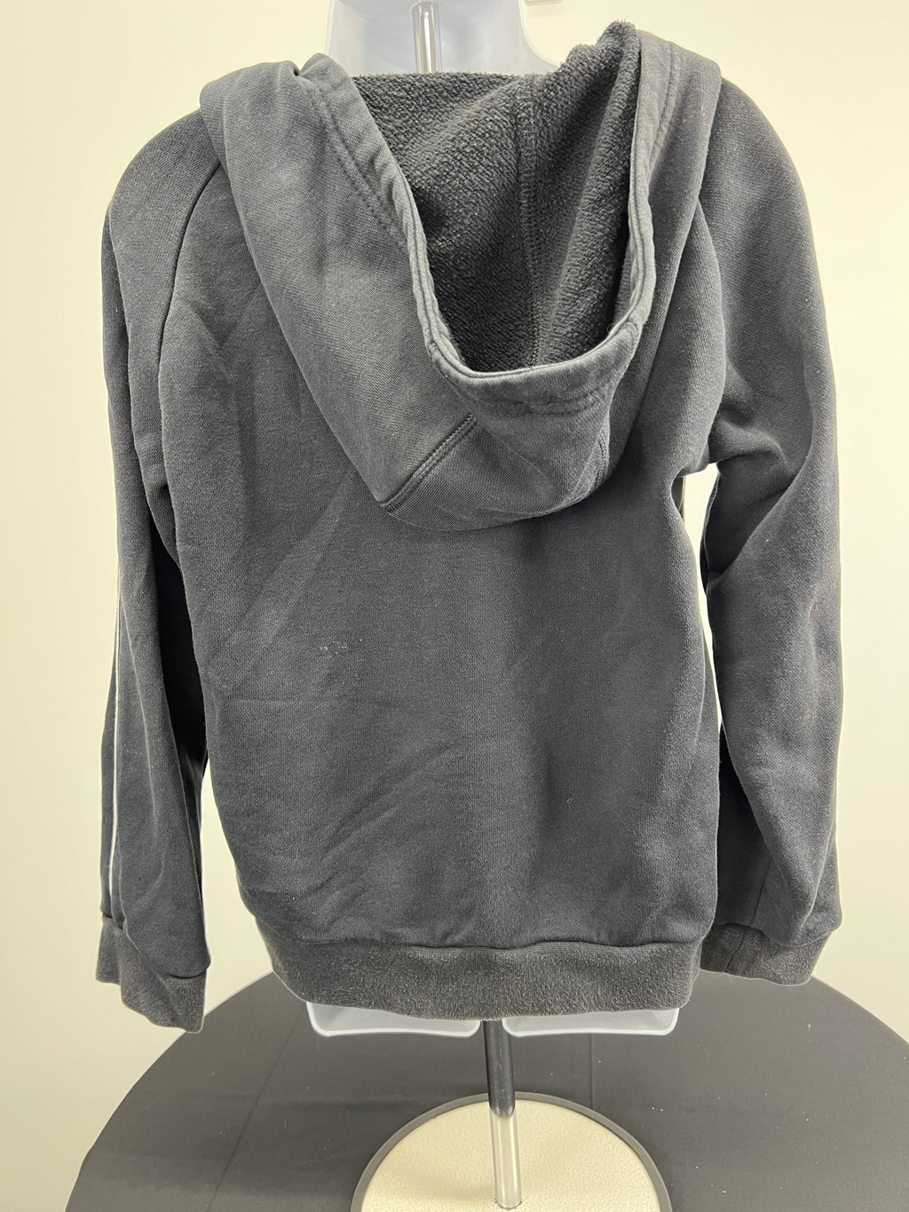 Back view of kids' black adidas hoodie showing fleece-lined hood and simple design