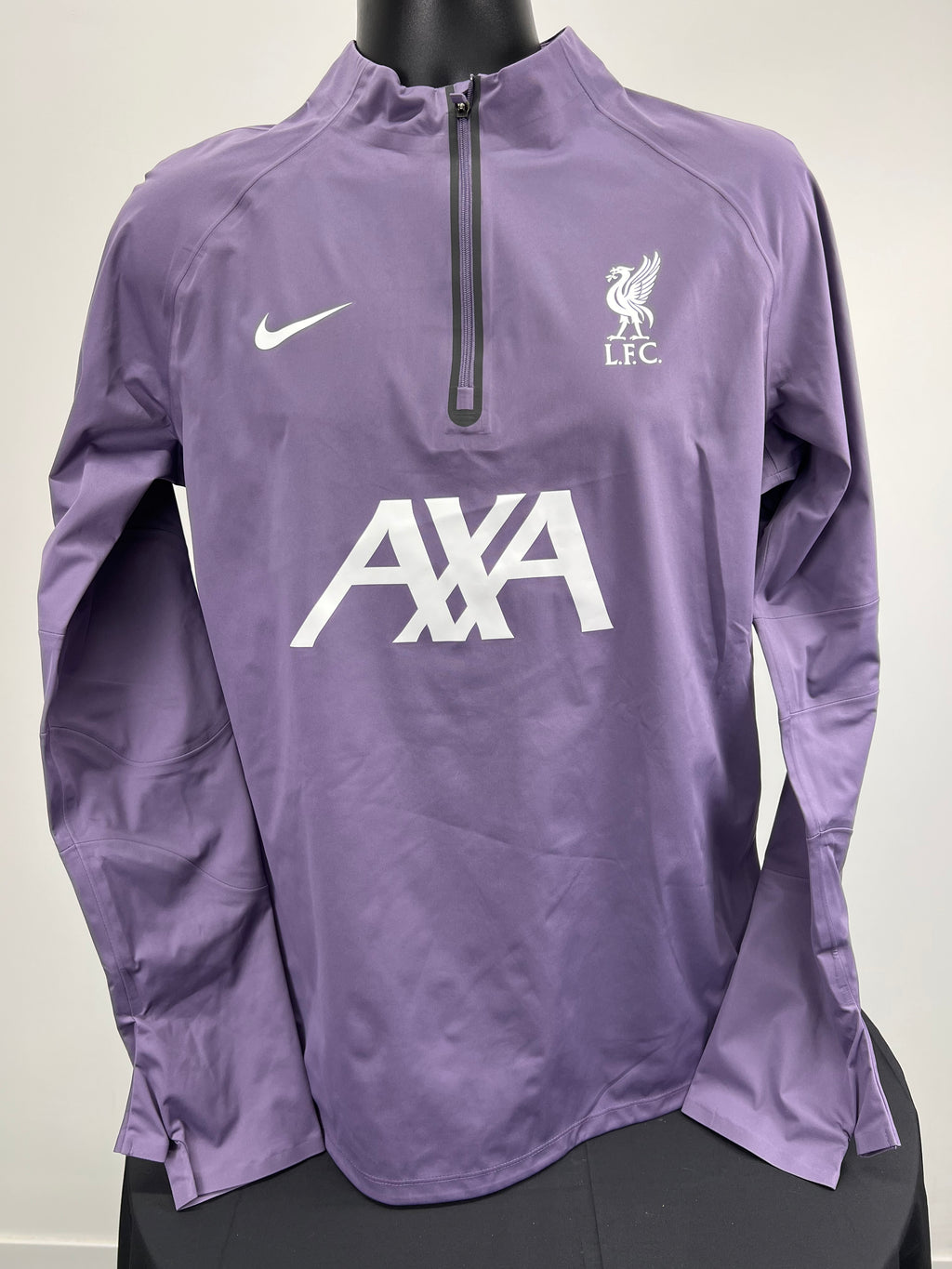 Front view of purple Nike Liverpool FC lightweight jacket with half zip and white logos