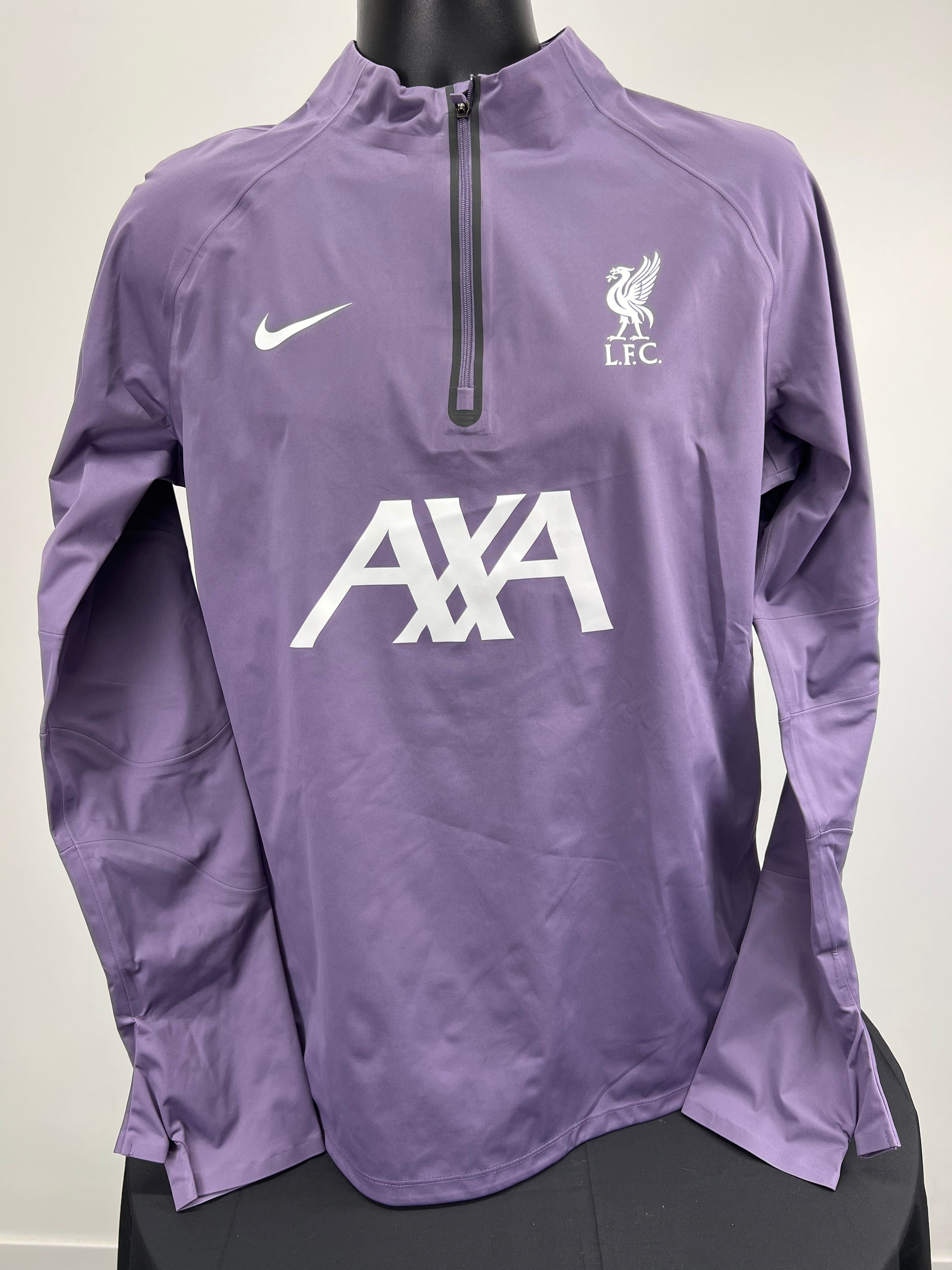 Front view of purple Nike Liverpool FC lightweight jacket with half zip and white logos