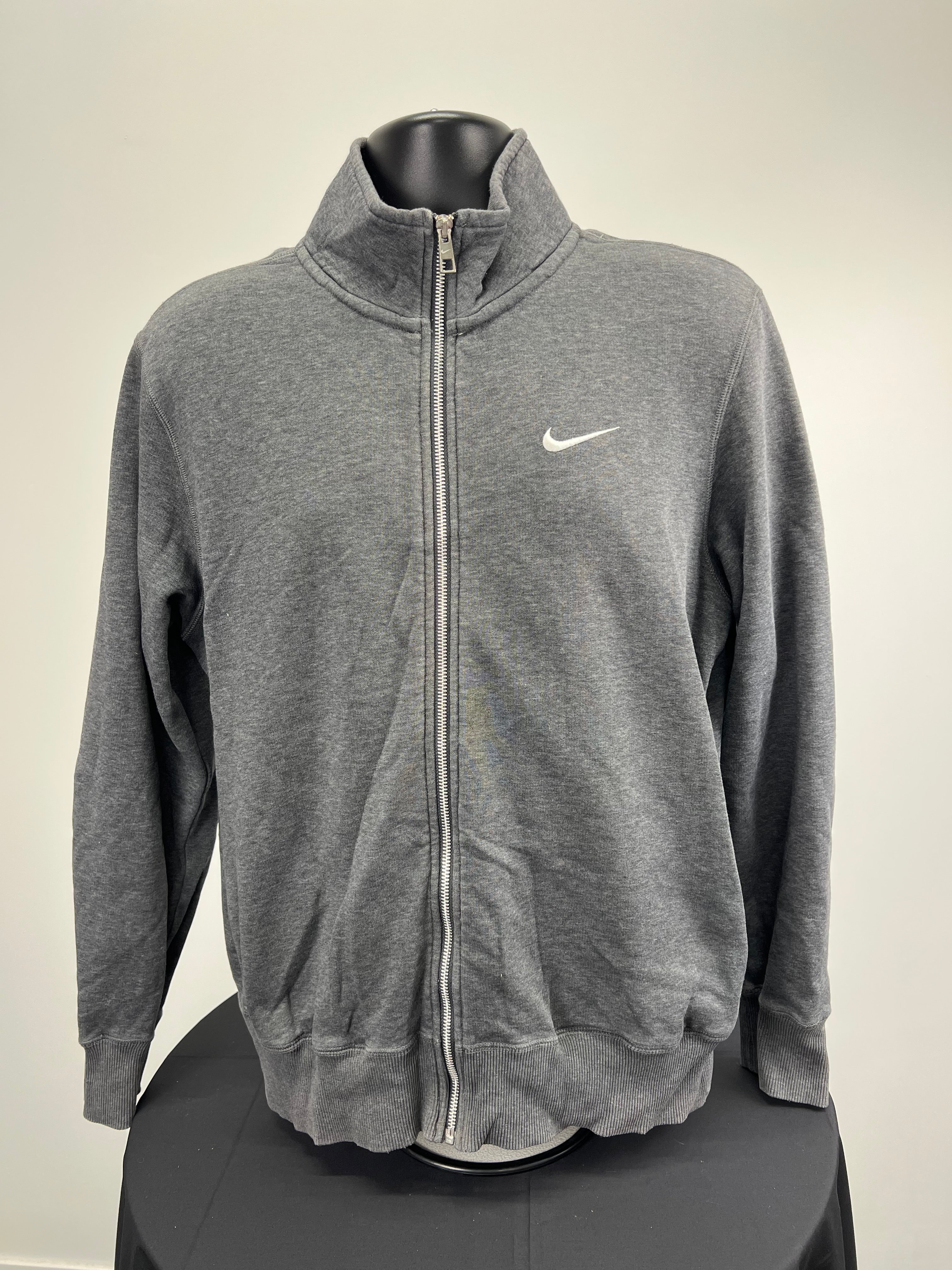 Front view of Nike medium grey zip-up top with white swoosh logo and silver zipper