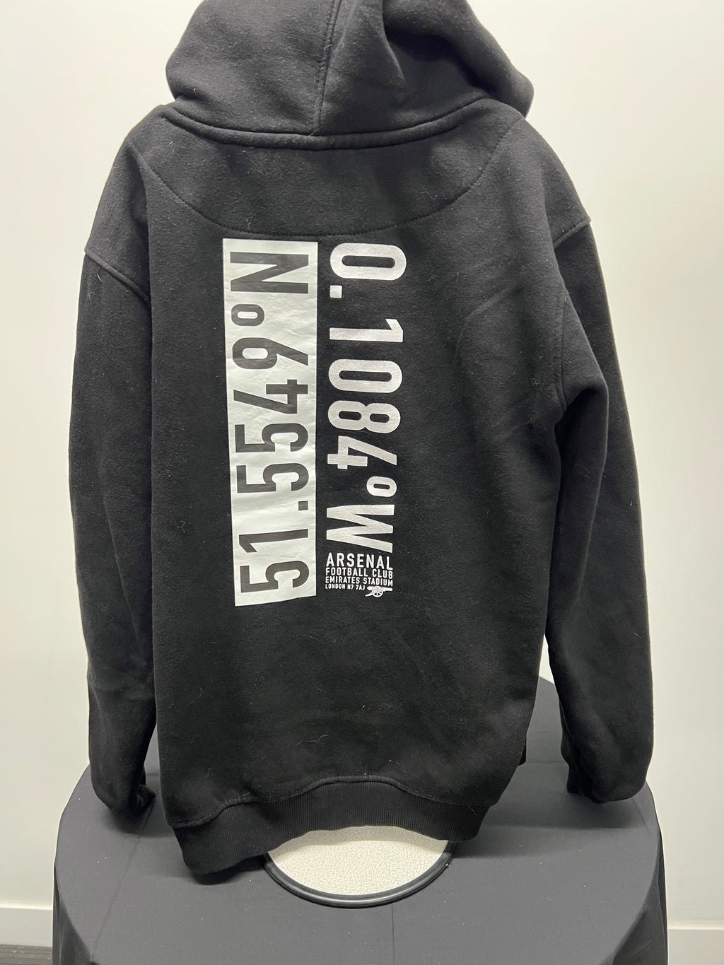 Back view of black kids Arsenal hoodie with white coordinates and football club logo print