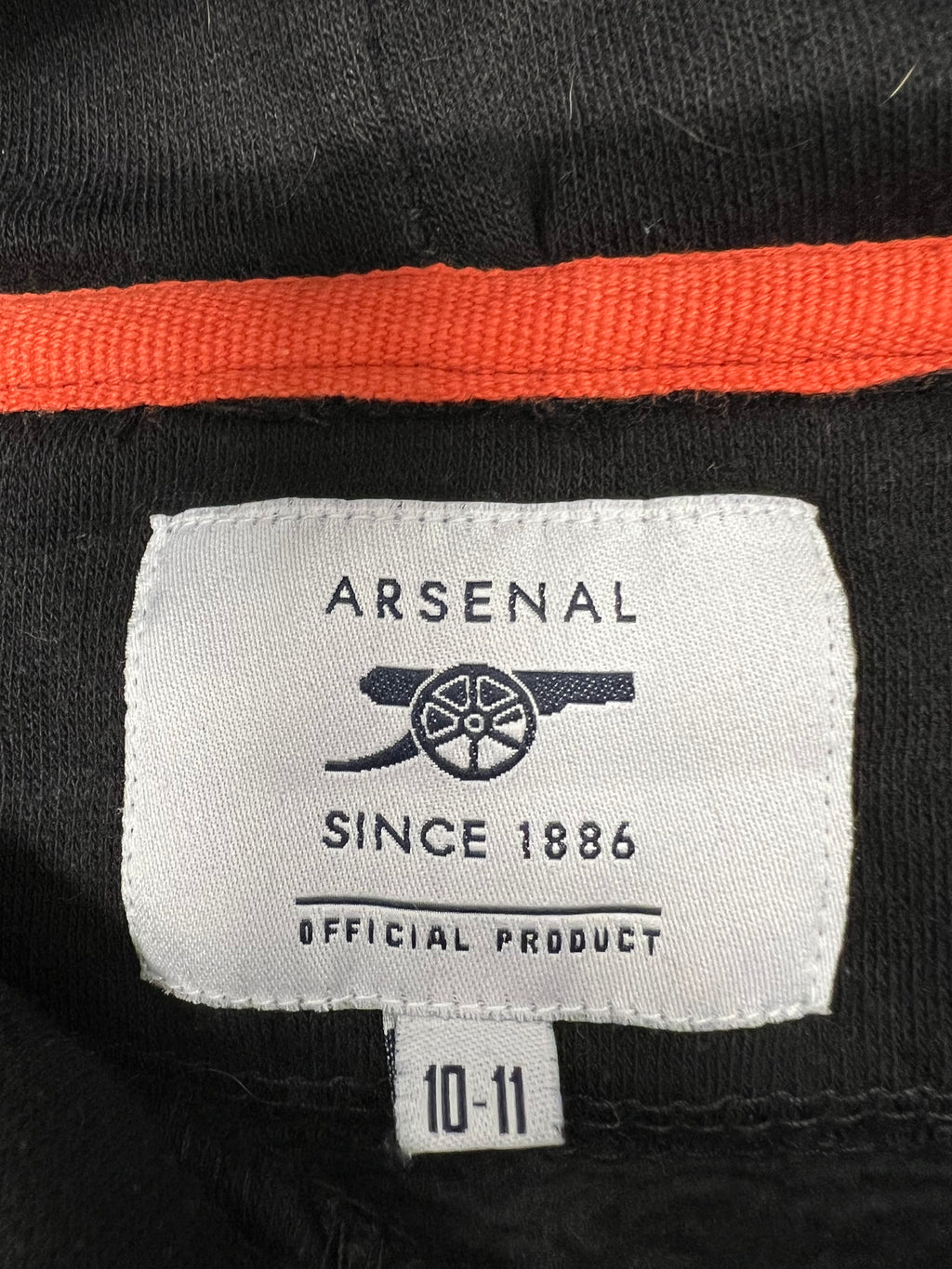 Close-up of Arsenal official product label on kids hoodie size 10-11