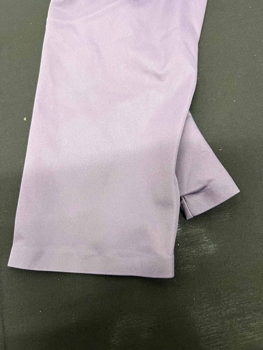 Close-up of the sleeve cuff showing purple fabric with thumb hole feature