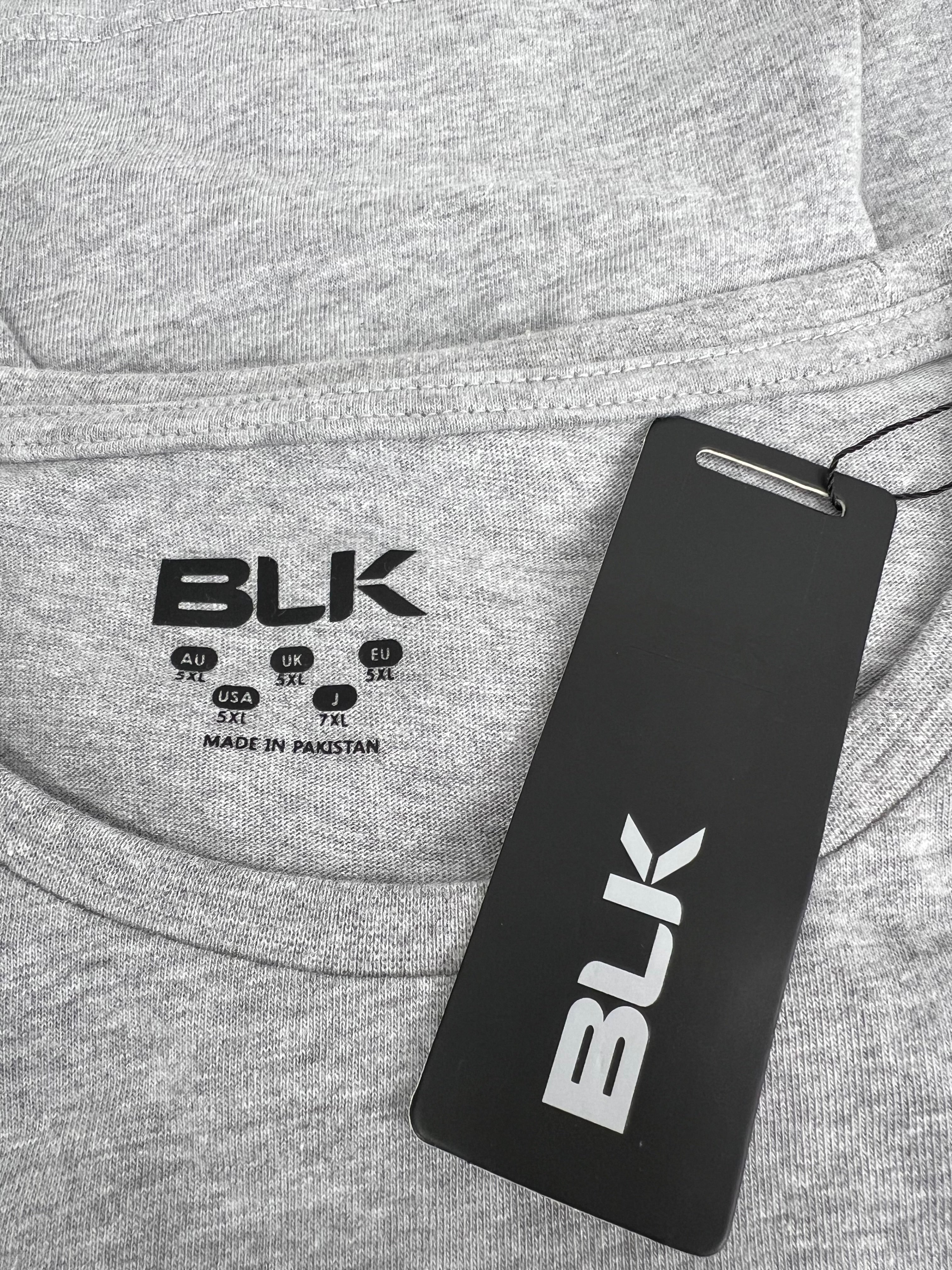 Close-up of BLK brand label and tag on grey Exiles print t-shirt