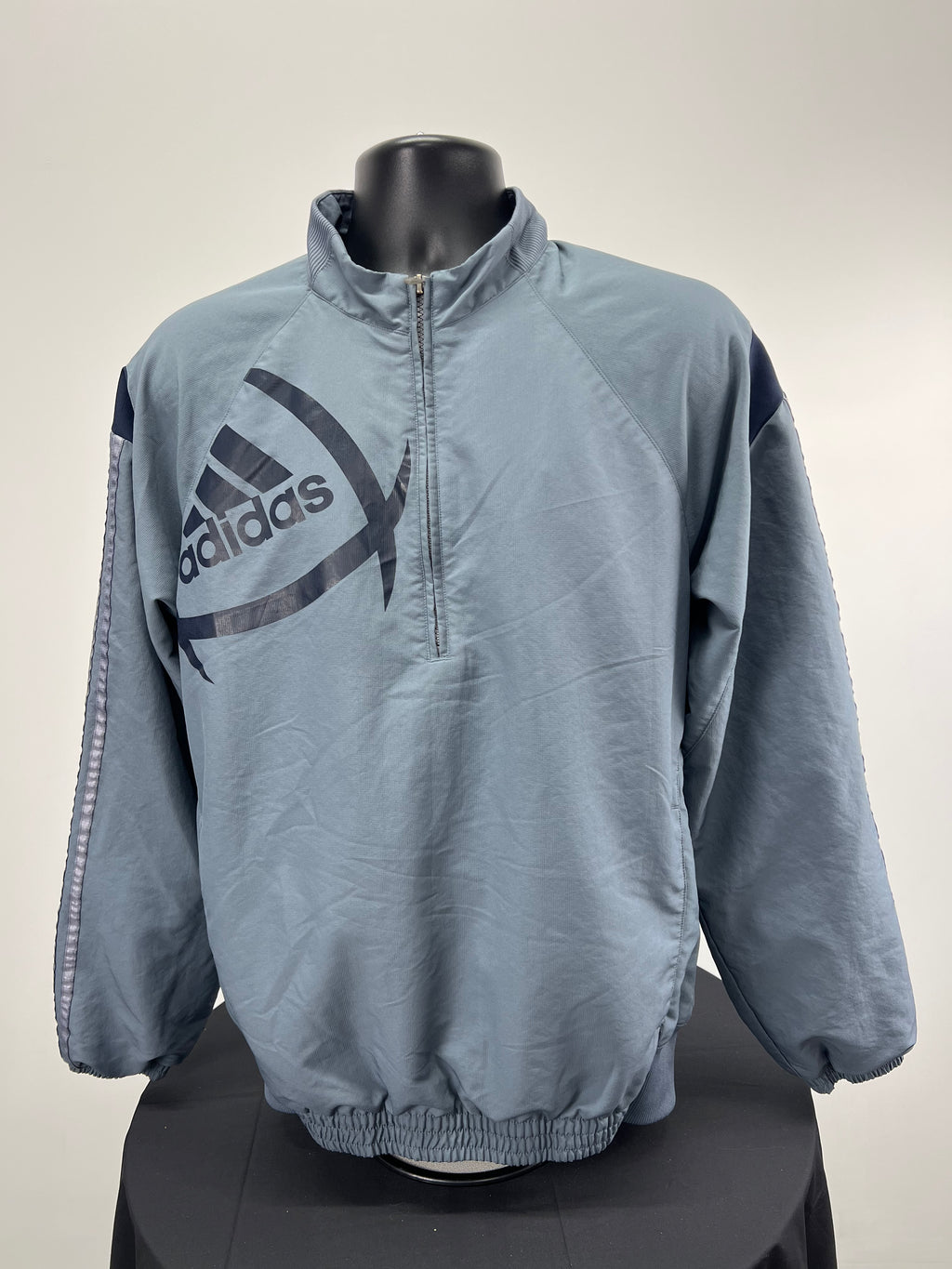 Front view of Adidas half zip grey top with large logo and elasticated waist and cuffs