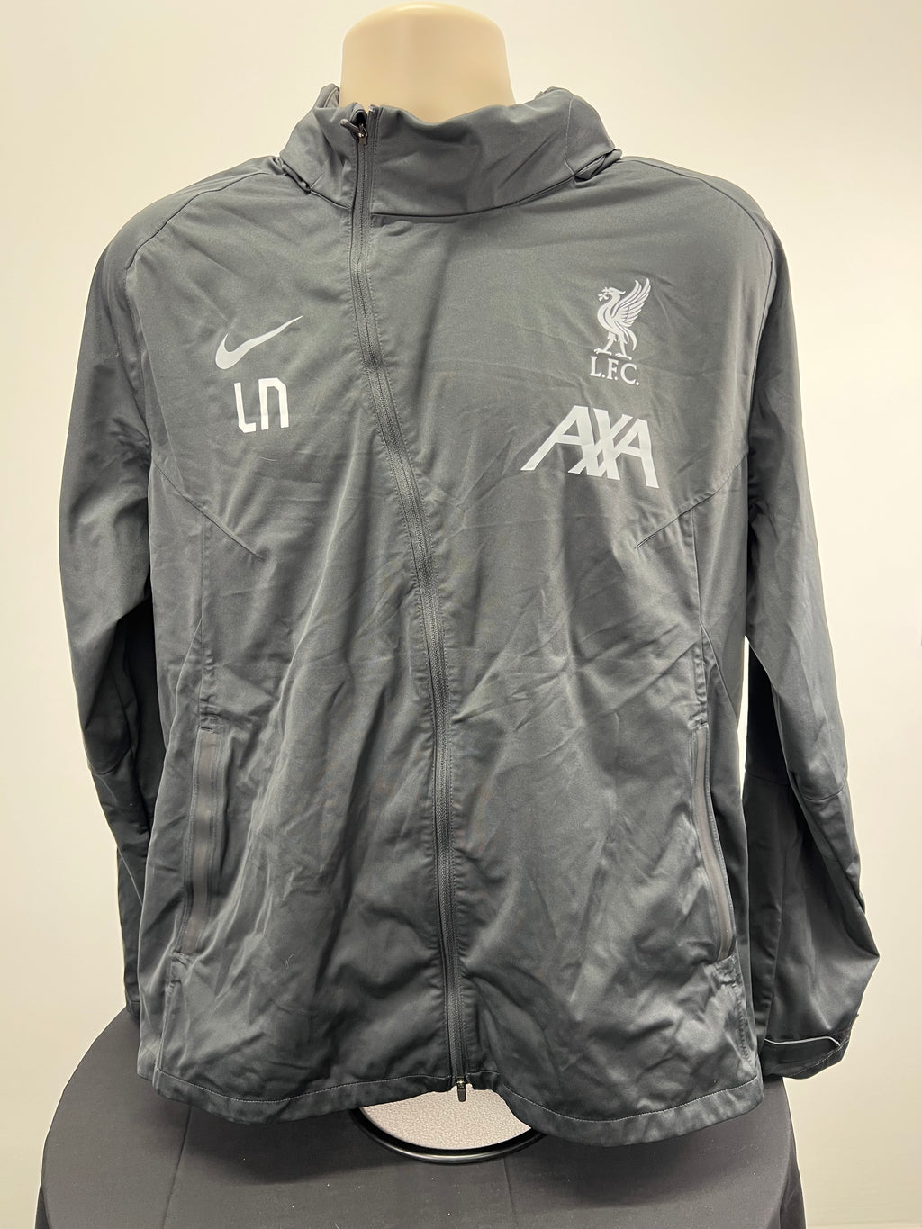 Front view of Nike LFC zip-up storm fit jacket in grey, showing Nike swoosh, LFC logo and AXA sponsor logos