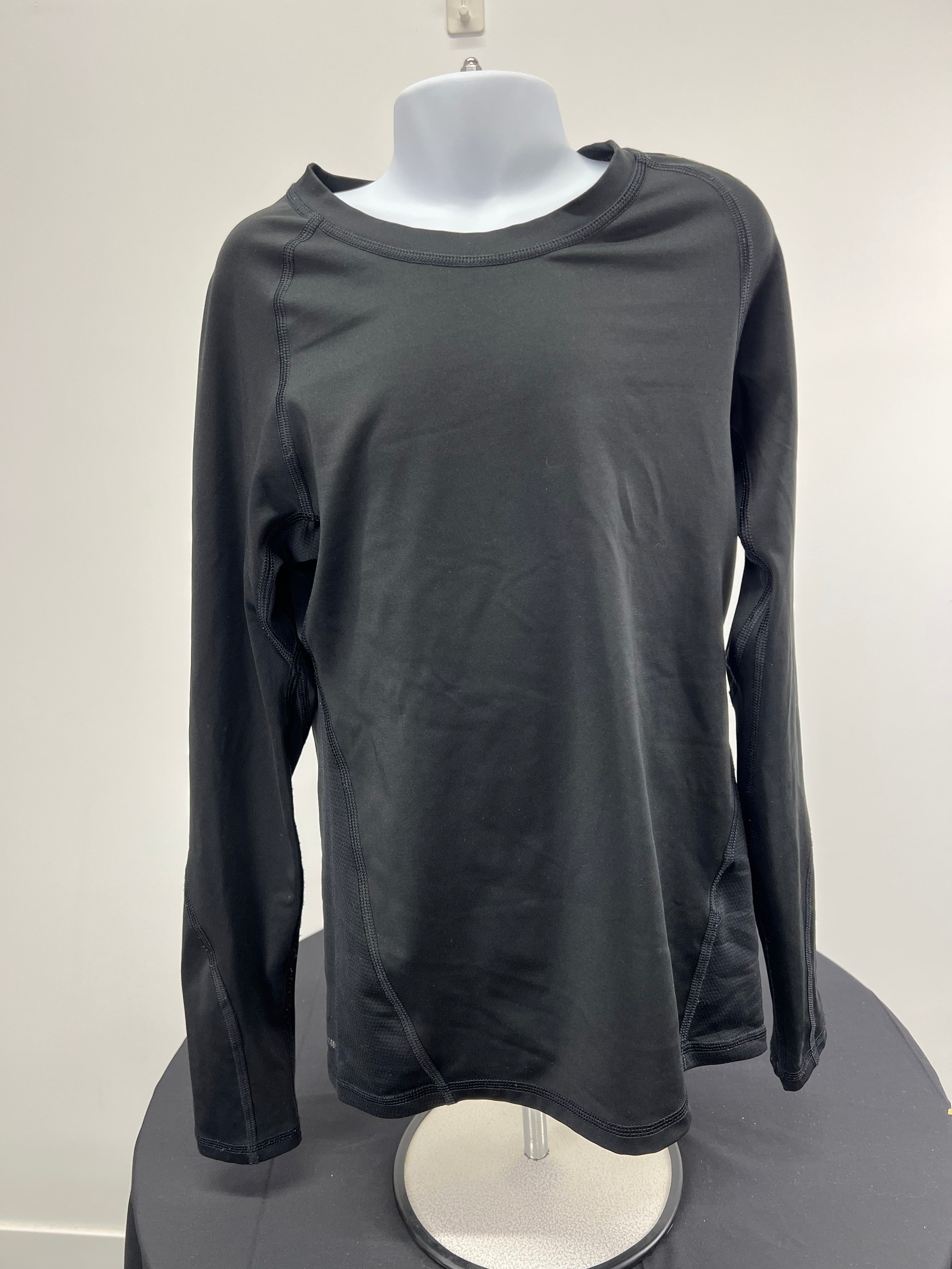 Front view of black adidas Techfit kids base layer long sleeve top on mannequin