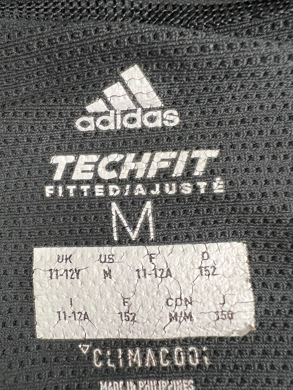 Close-up of adidas Techfit Climacool label and size medium details inside the base layer