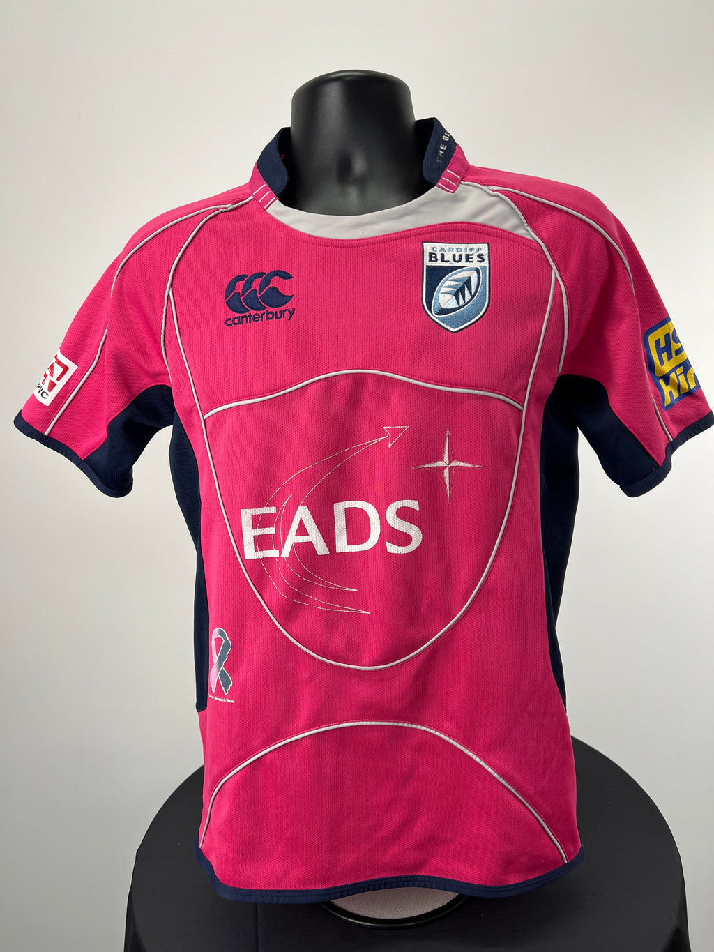 Front view of men’s Canterbury Cardiff Blues rugby top in bright pink with navy side panels and logos