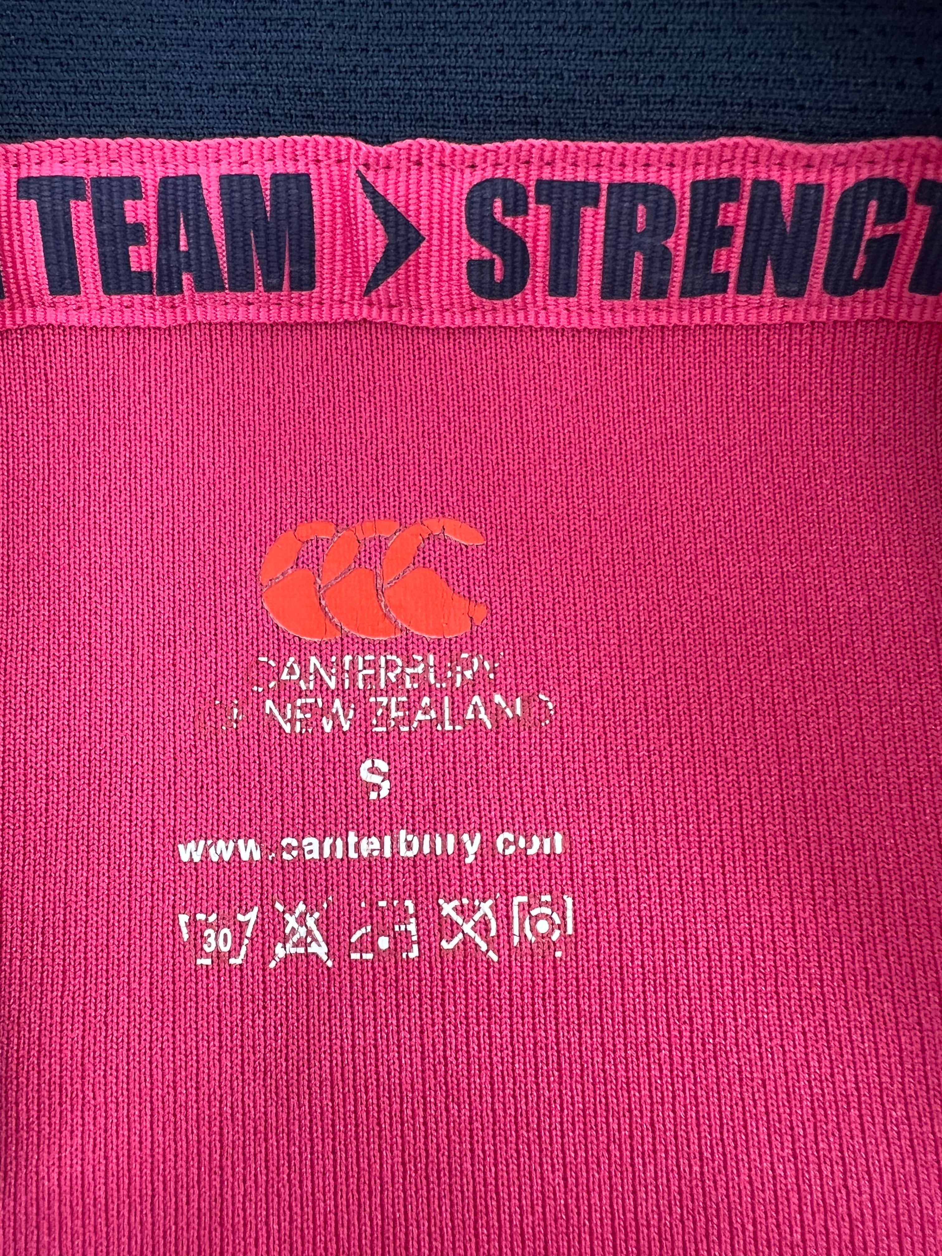 Close-up of neckline inside label showing Canterbury branding, size S, and washing instructions
