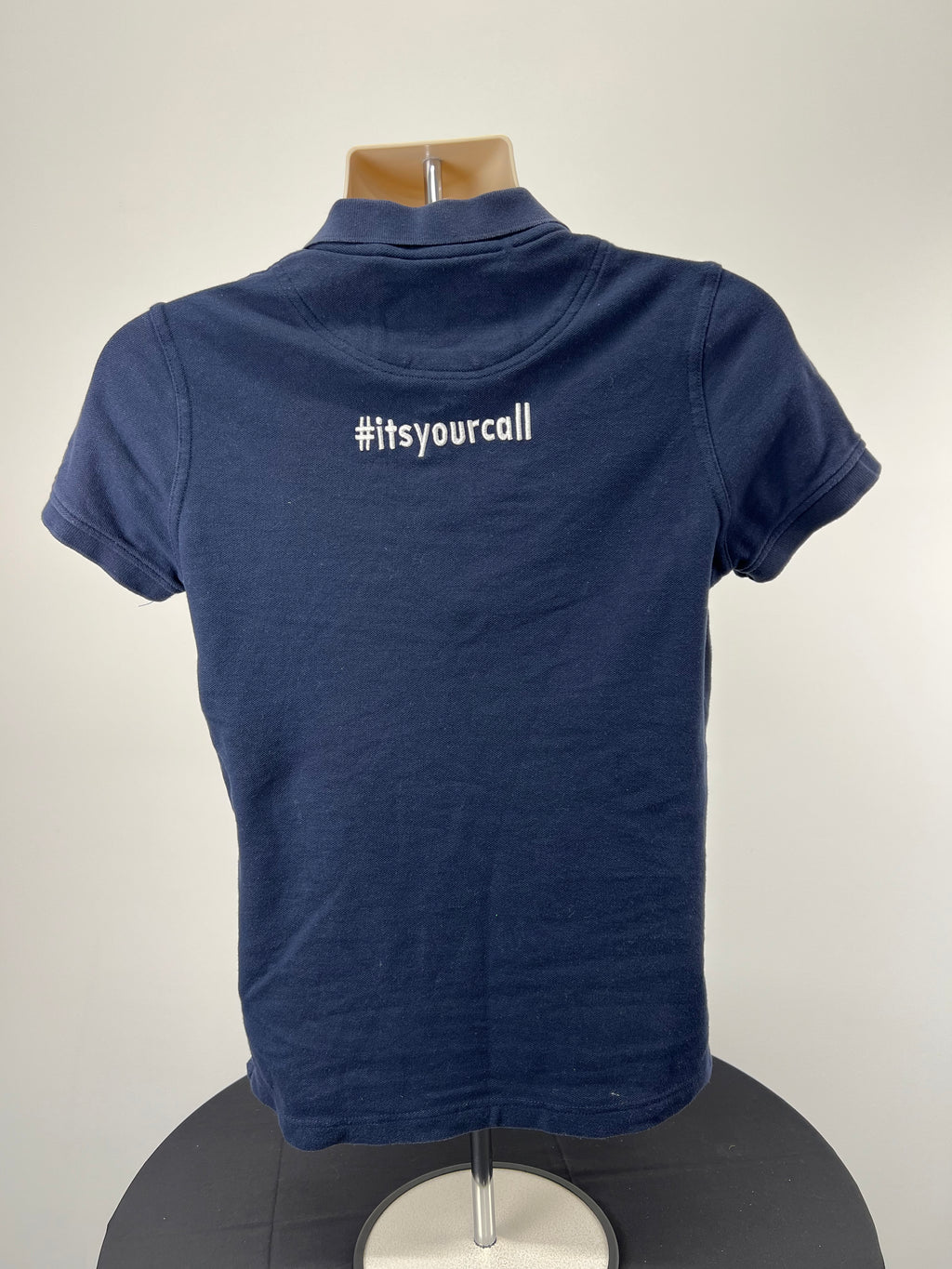 Back view of dark blue polo shirt showing #itsyourcall embroidery