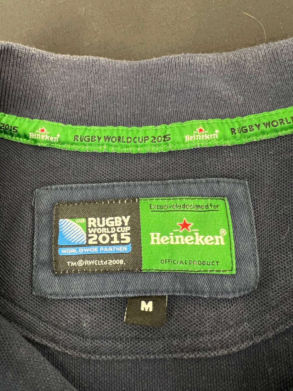 Close-up of label inside collar of Rugby World Cup 2015 Heineken polo shirt size M