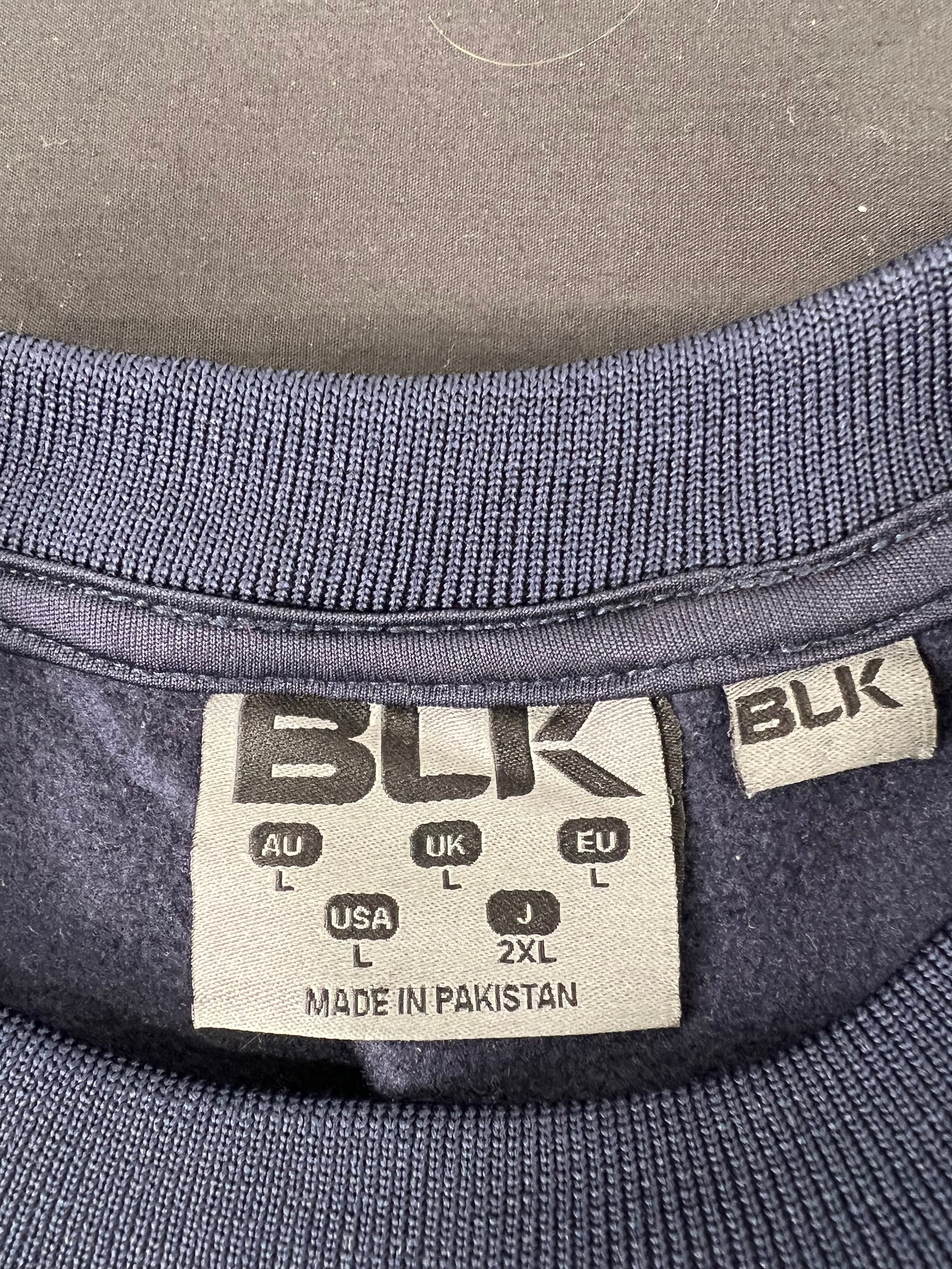 Close-up of BLK label inside men's London Irish sweatshirt showing size L and made in Pakistan