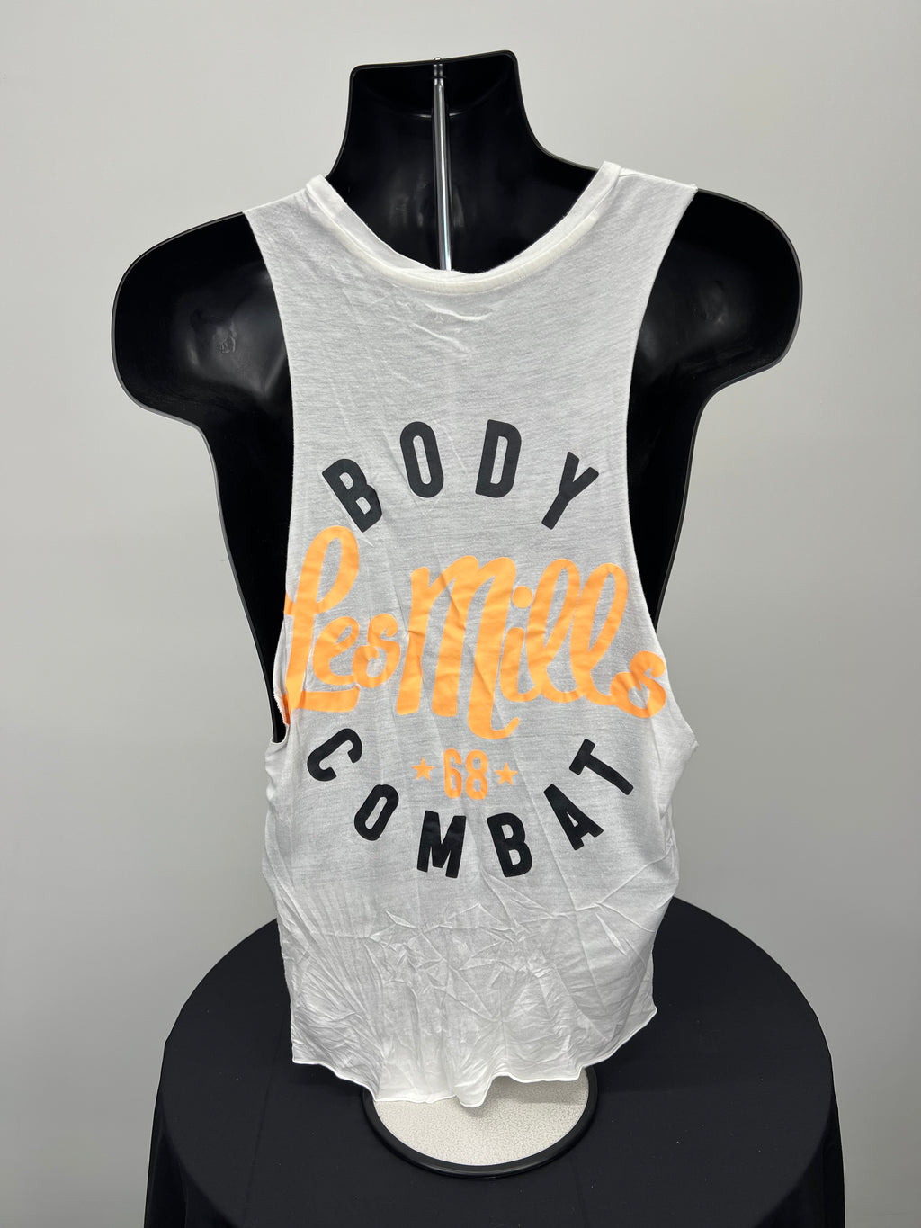 Back view of white Reebok Body Combat vest featuring large orange and black Les Mills graphic