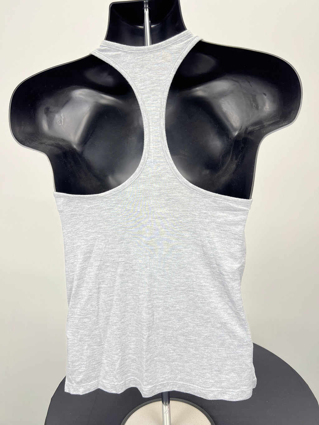 Back view of grey racerback sports vest on mannequin