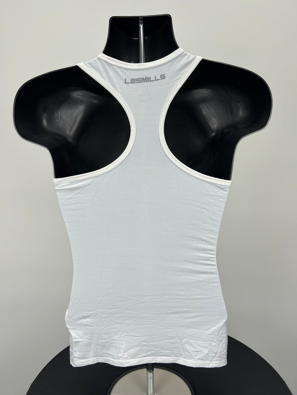 Back view of white racerback Women’s Reebok Les Mills sports vest
