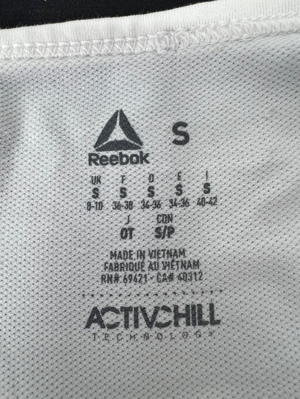 Close-up of inside tag showing Reebok logo, size S, and ActiVchill technology label