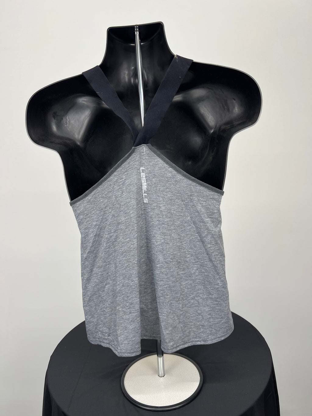 Back view of grey Reebok Body Combat women’s training vest showing black racerback straps on mannequin