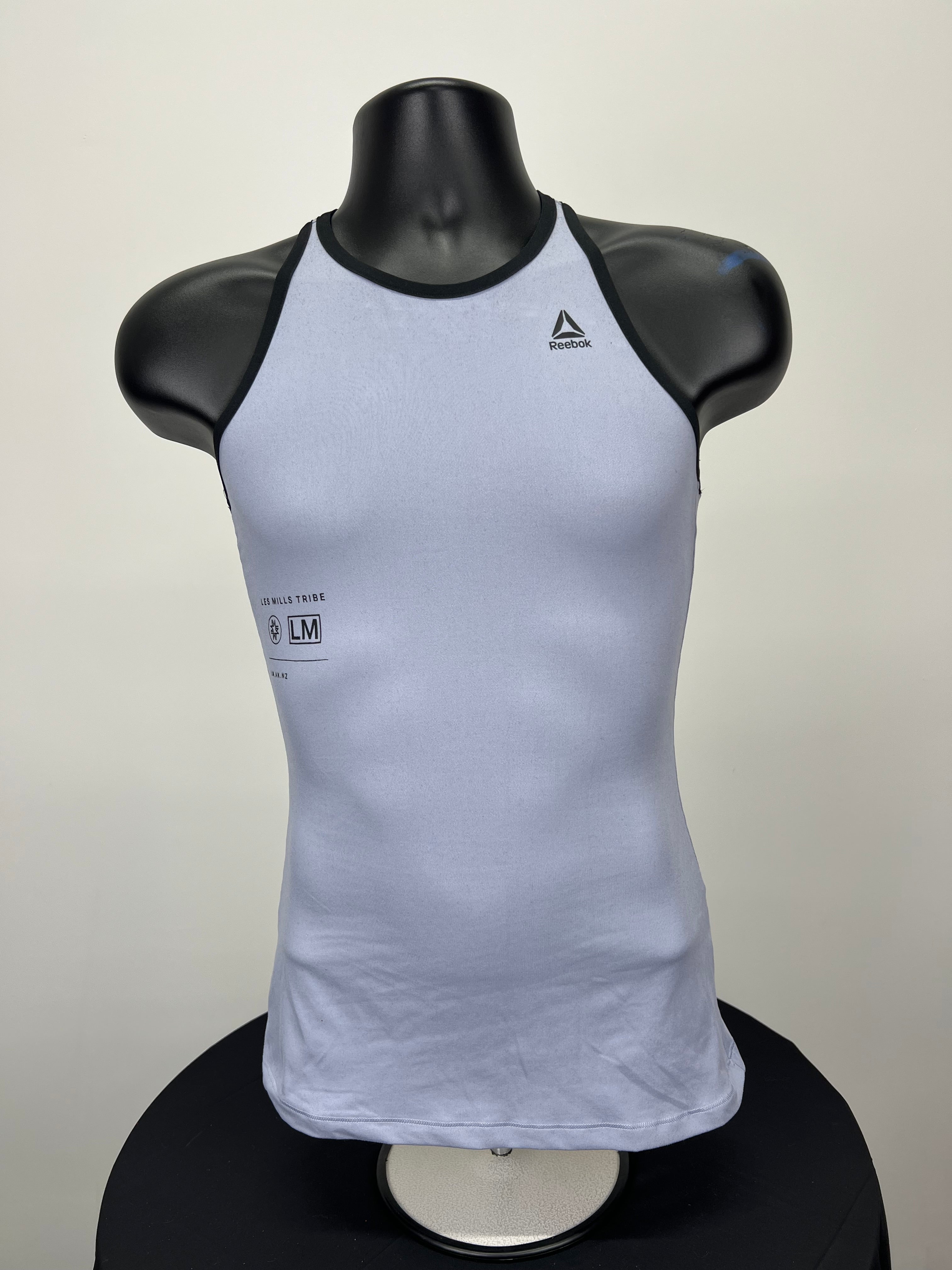 Front view of grey Reebok x Les Mills vest top on mannequin with black trim and logos