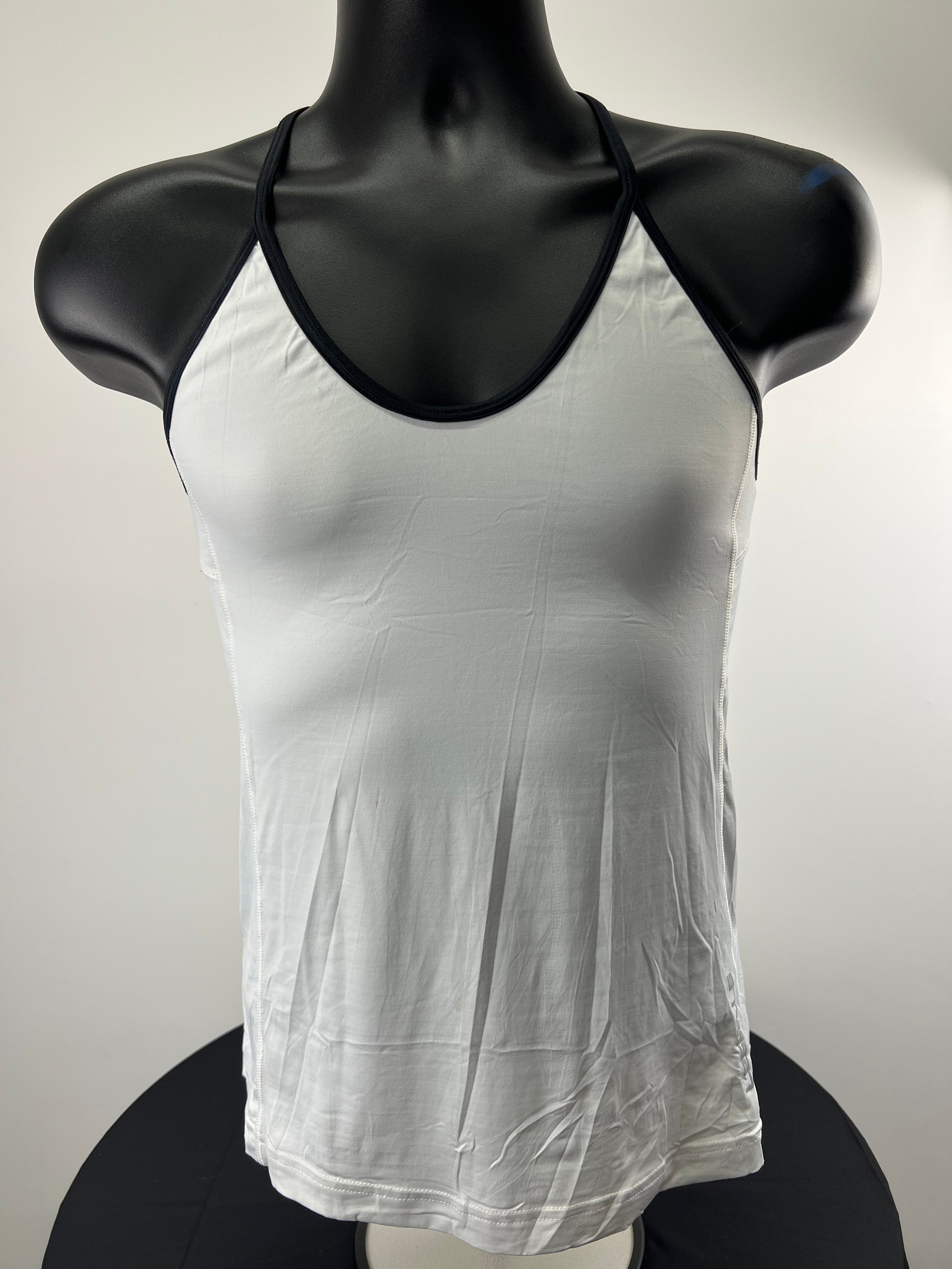 Front view of white women's Reebok x Les Mills training vest with black trim on mannequin