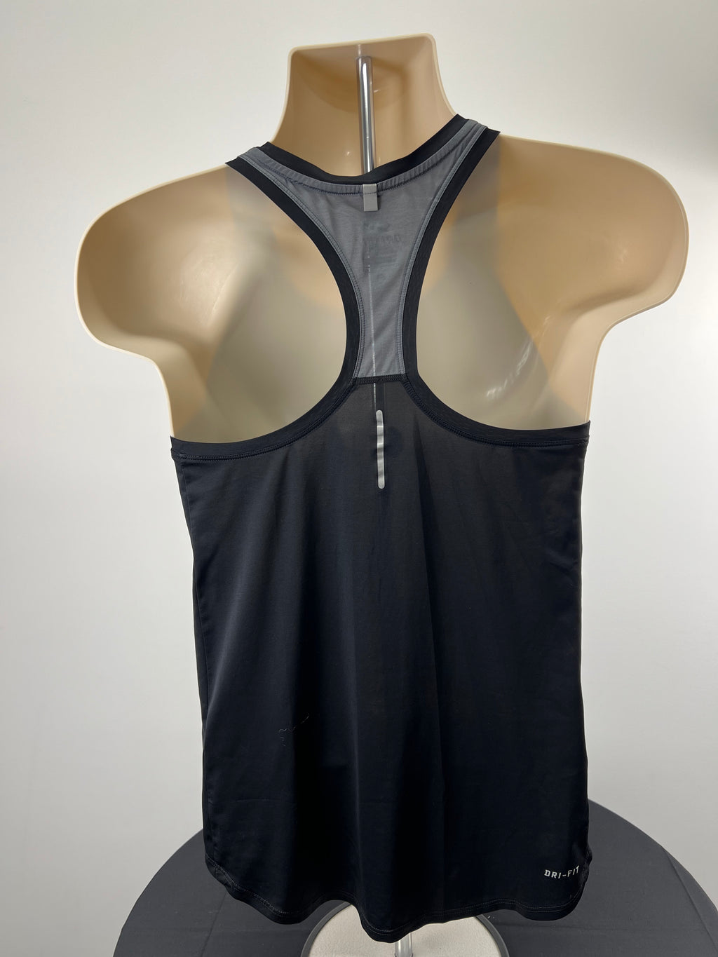 Back view of black Nike racer back vest showing grey detailing and reflective strip