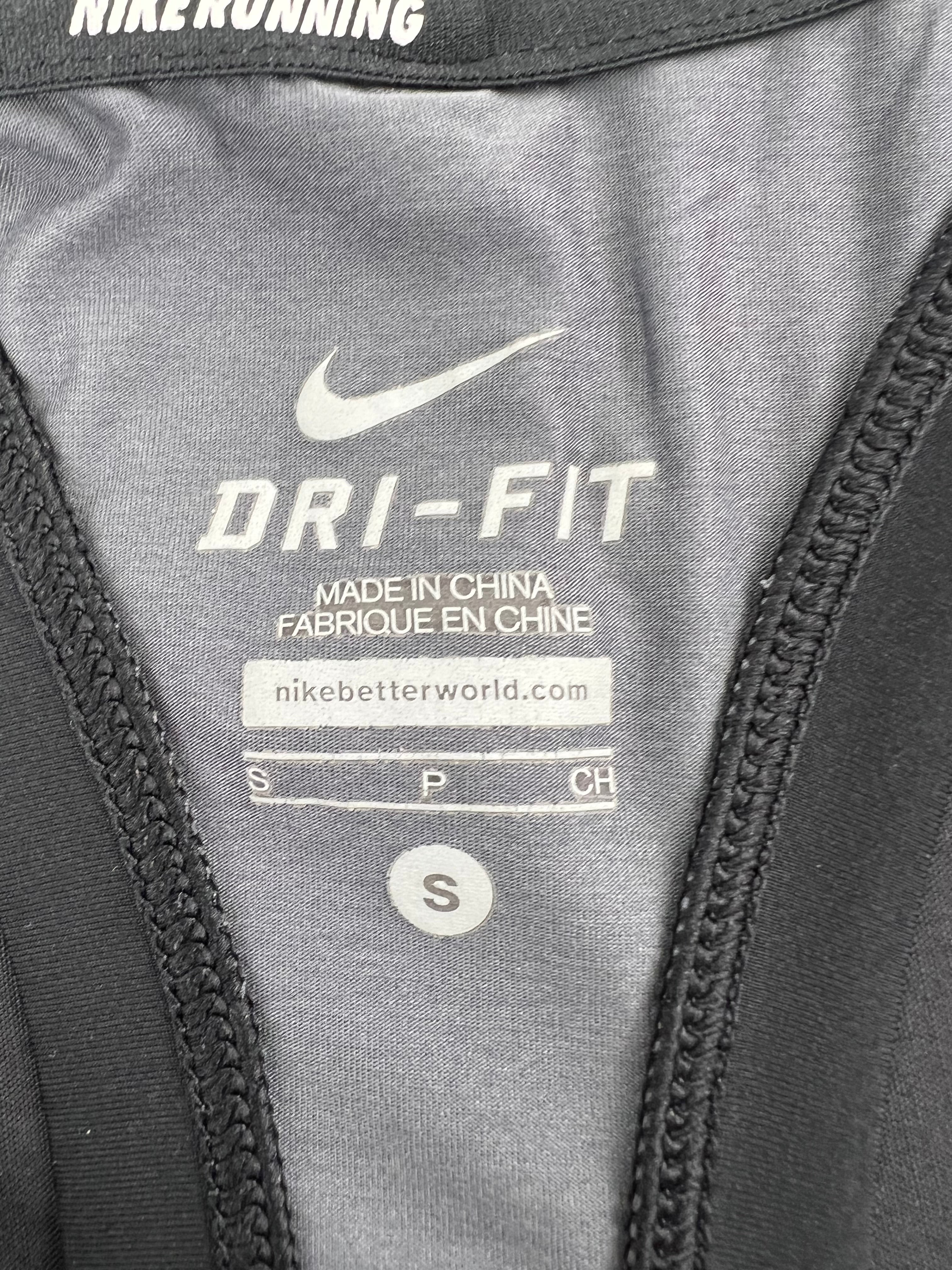 Close-up of Nike Dri-FIT label inside black vest showing size small and manufacturing details