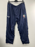 Front view of navy blue Men’s BLK London Irish tracksuit bottoms hung on a hanger