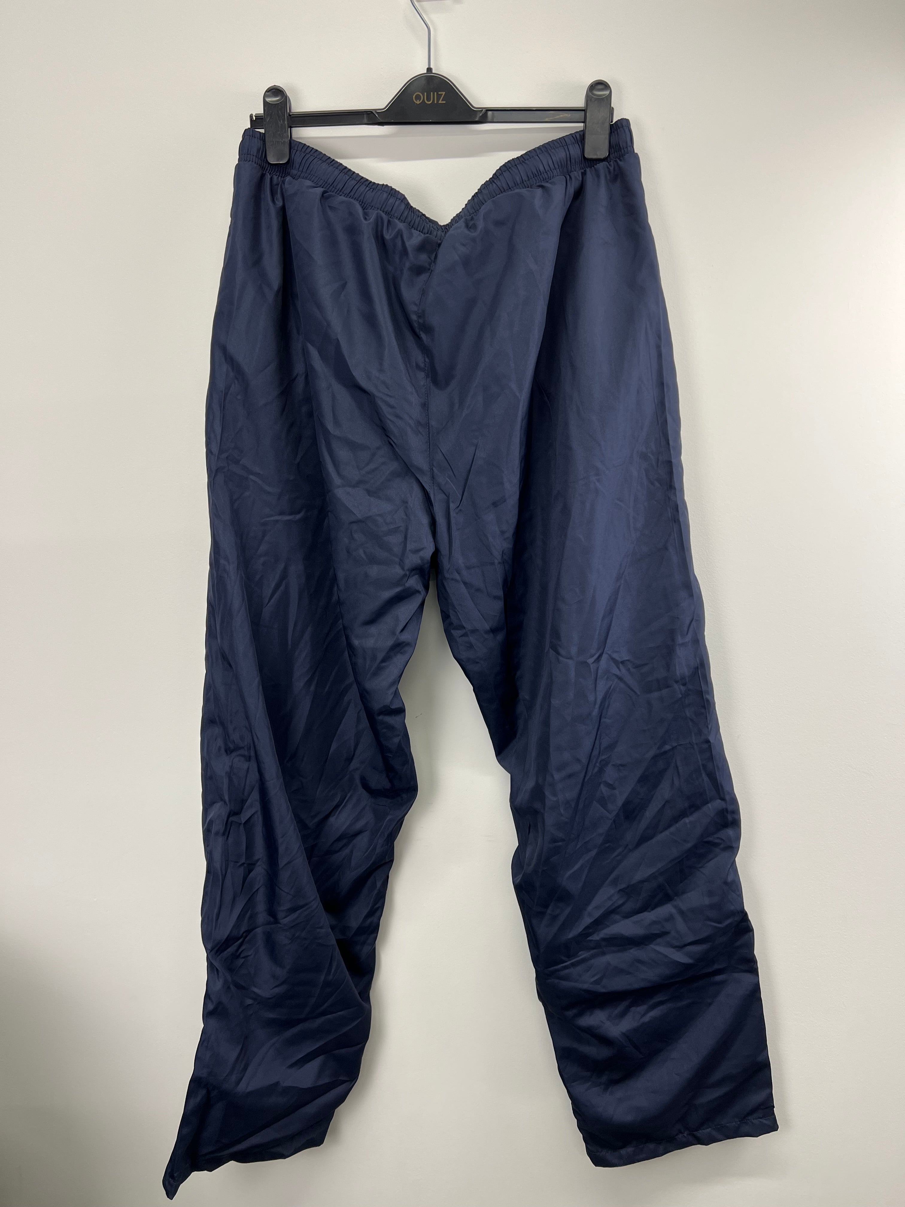 Back view of men's navy blue BLK London Irish tracksuit bottoms showing elastic waistband