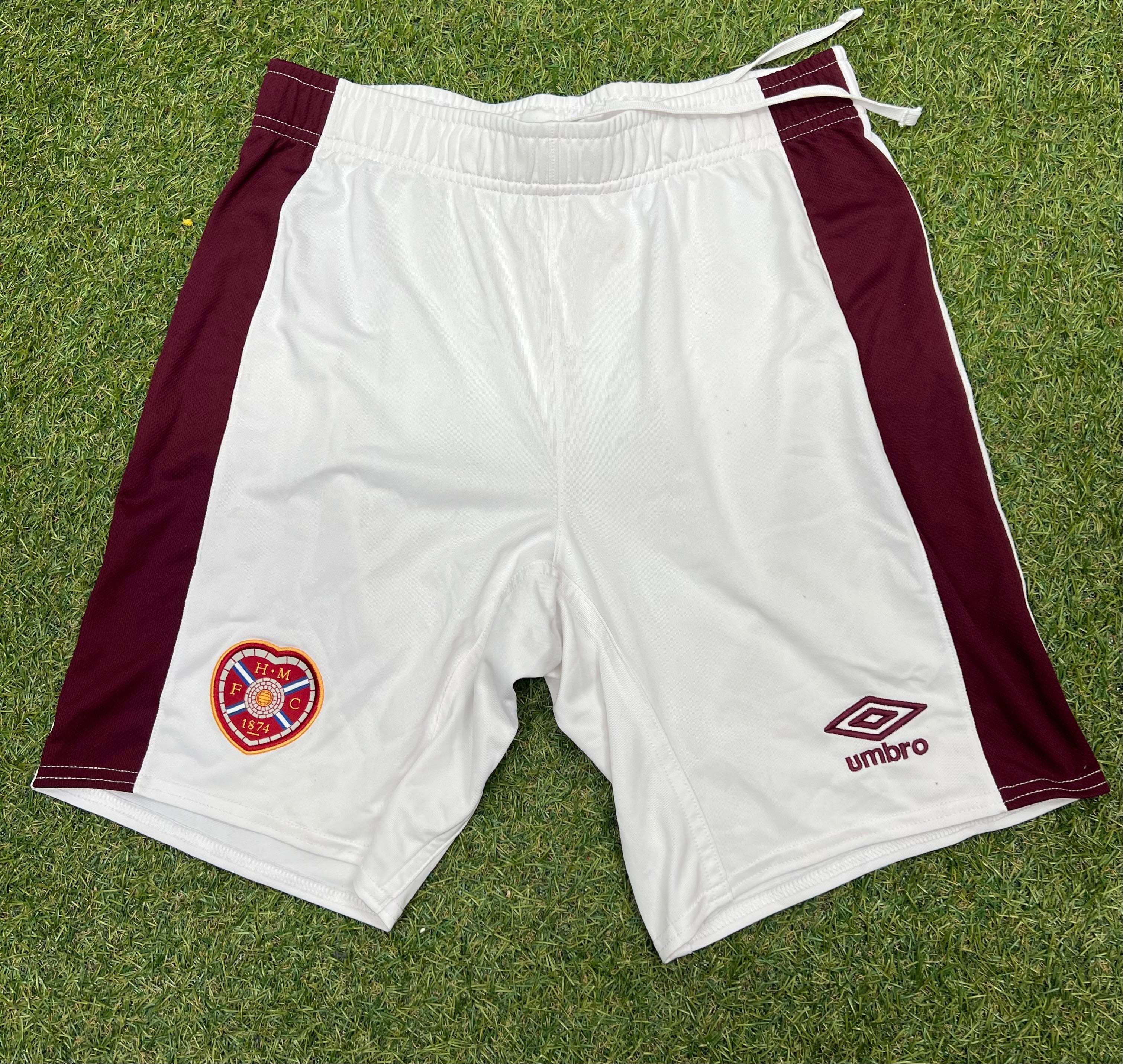 Front view of Men’s Umbro Hearts FC football shorts in white with maroon side panels, showing Hearts FC crest and Umbro logo
