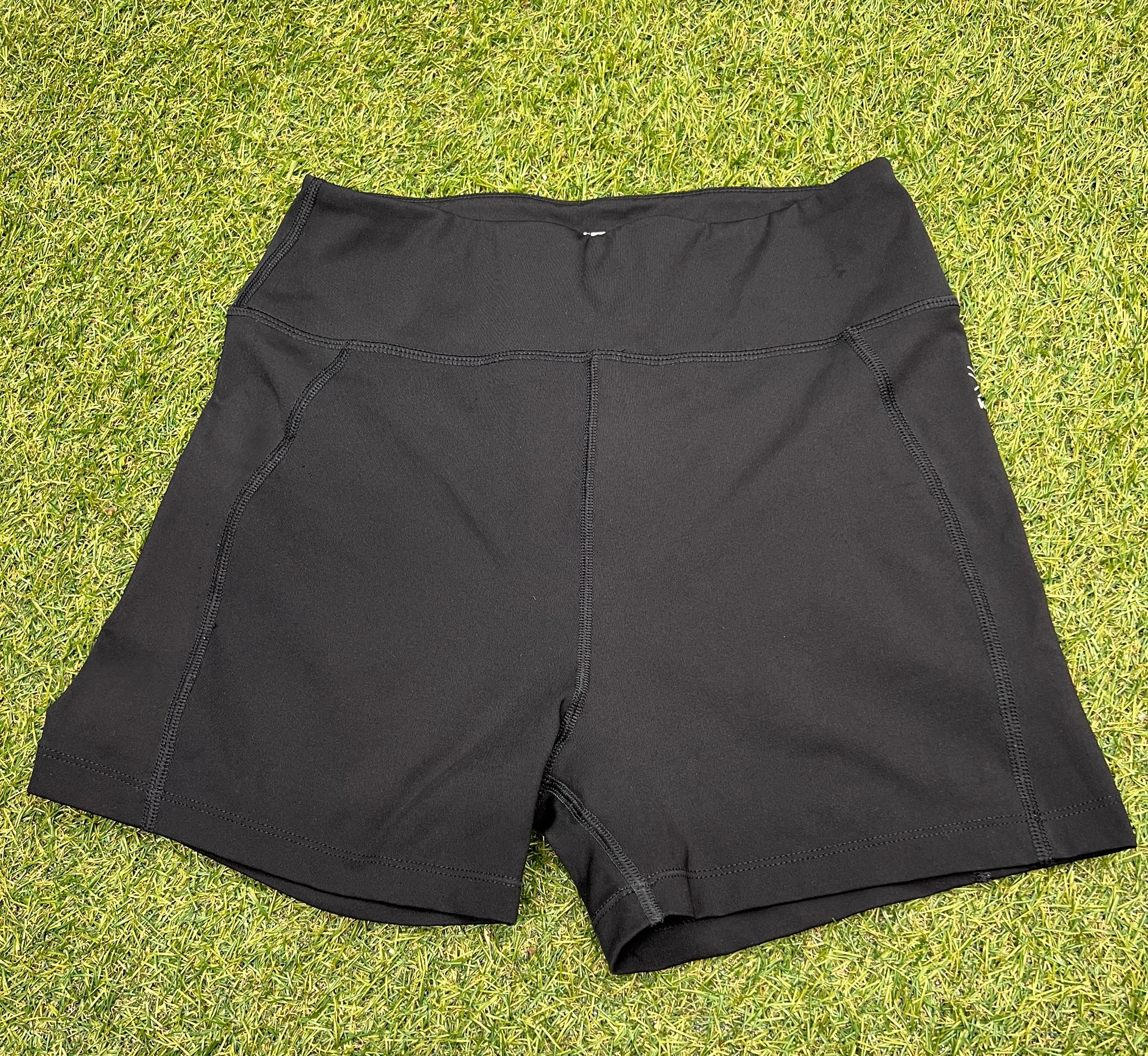 Front view of women’s black Karrimor running shorts showing wide waistband and stitching details