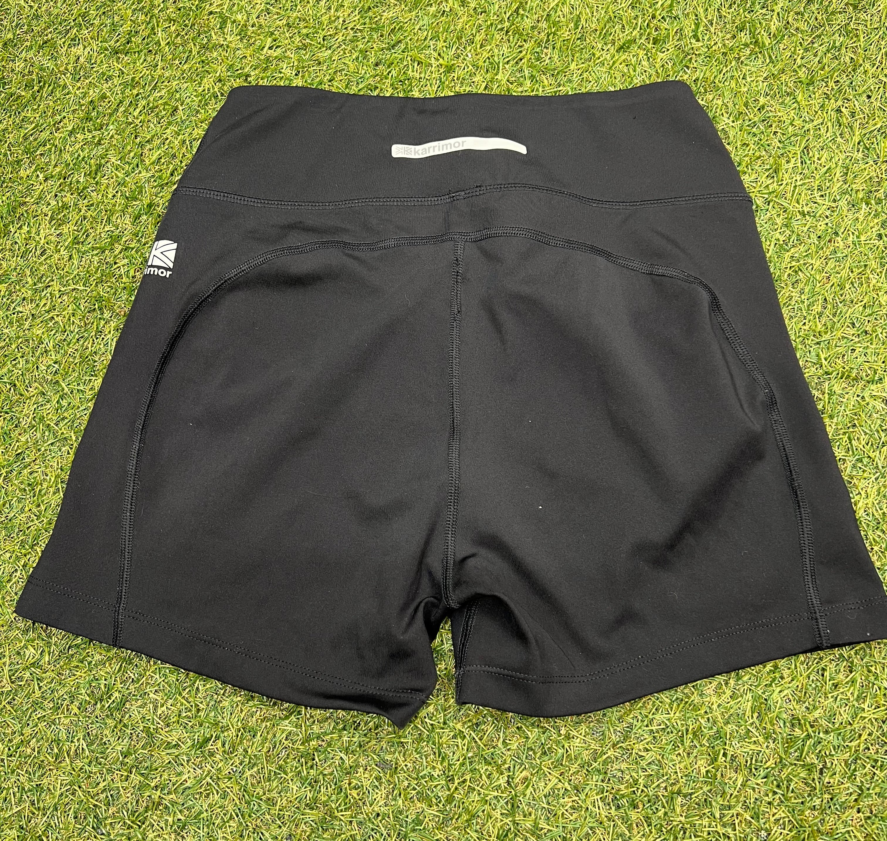 Back view of women’s black Karrimor running shorts highlighting reflective logo and seam design