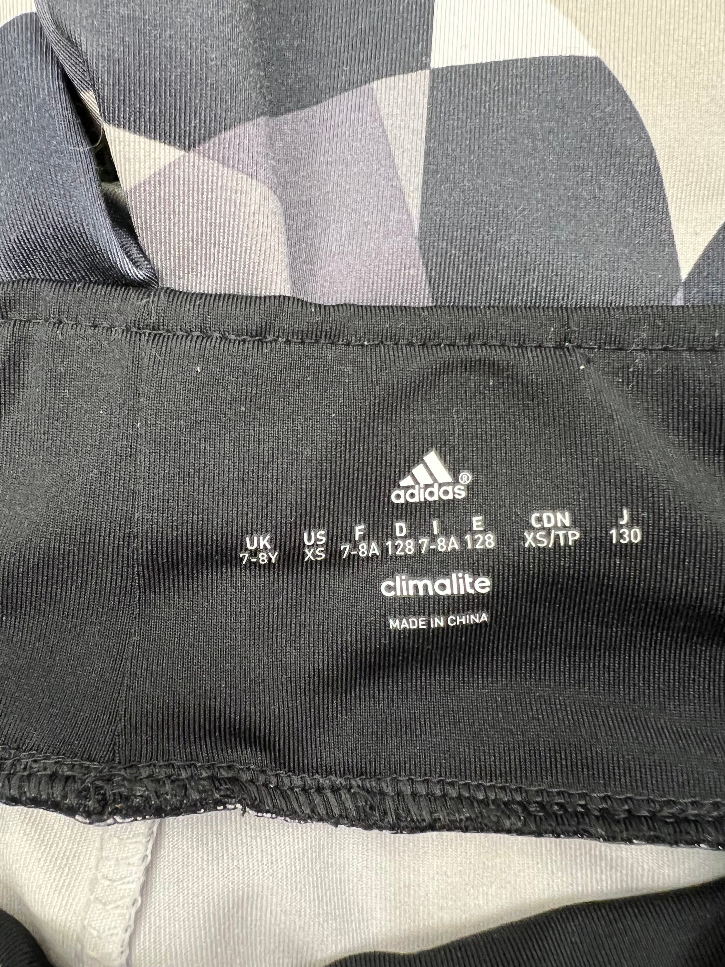 Close-up of adidas Climalite label and size print inside waistband of kids leggings