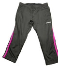 Front view of Asics black cropped leggings with pink side stripes laid flat on grass