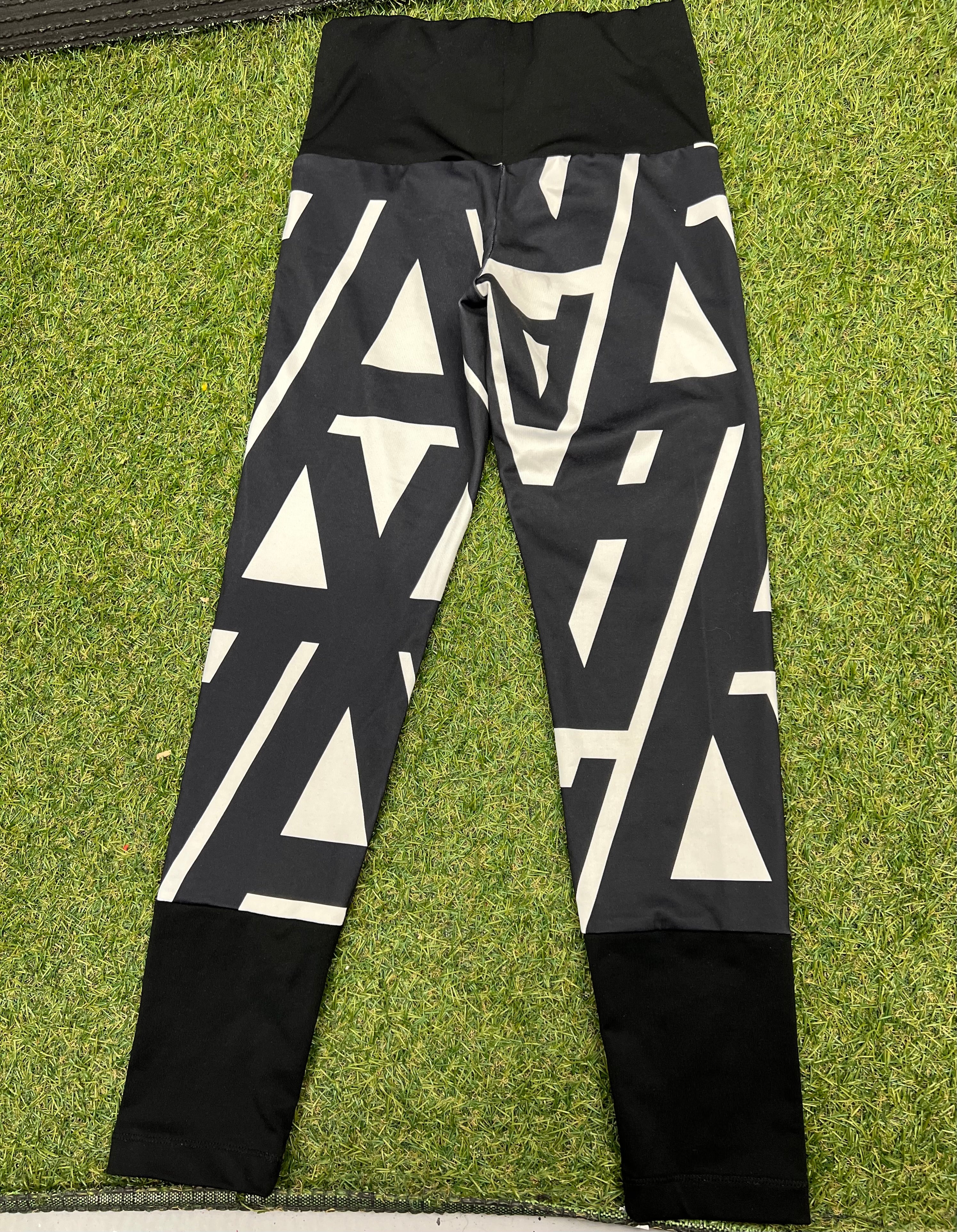 Back view of Adidas kids leggings showing high waistband and bold black and white geometric design
