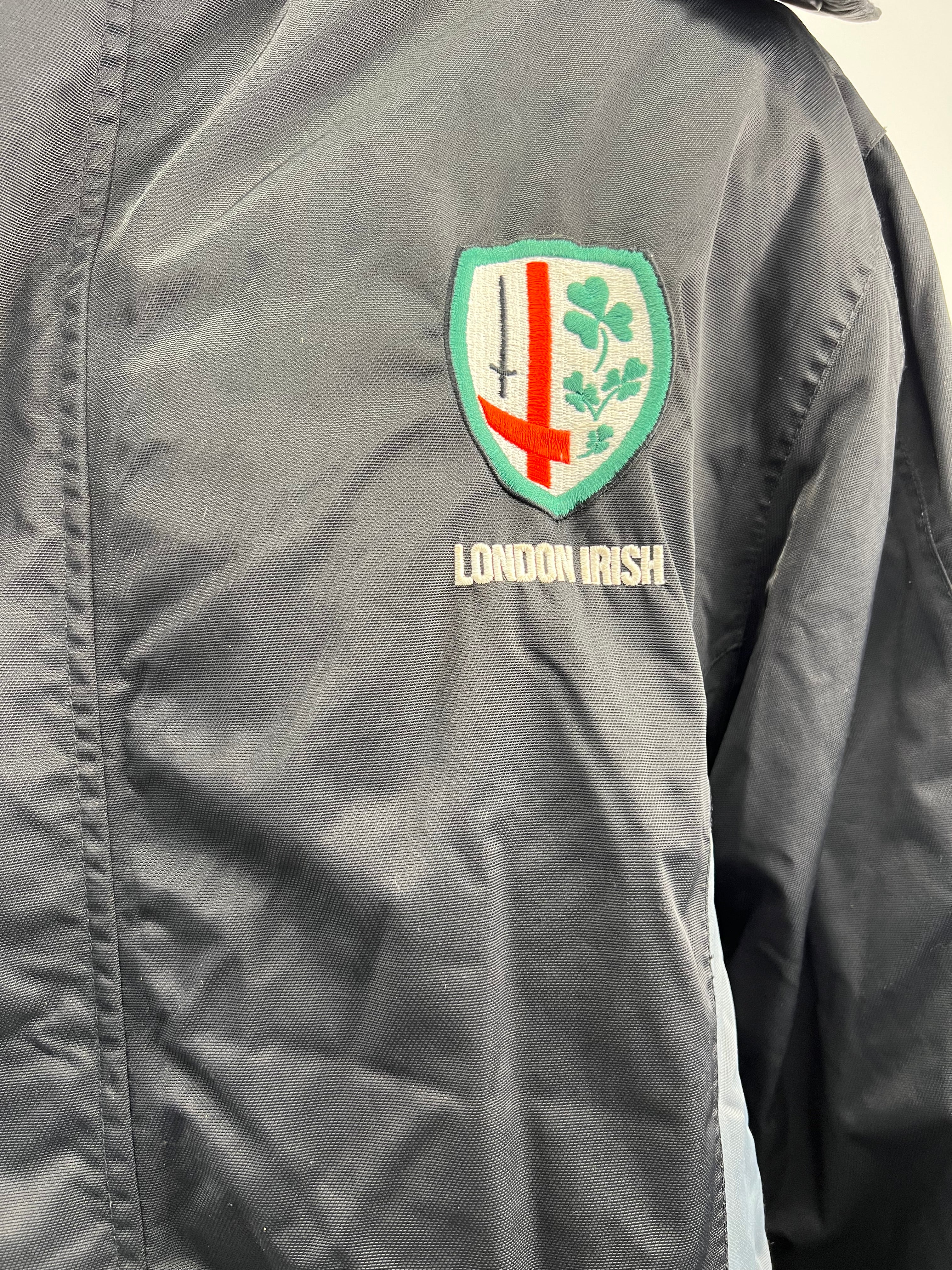 Close-up of embroidered London Irish crest on chest of black jacket