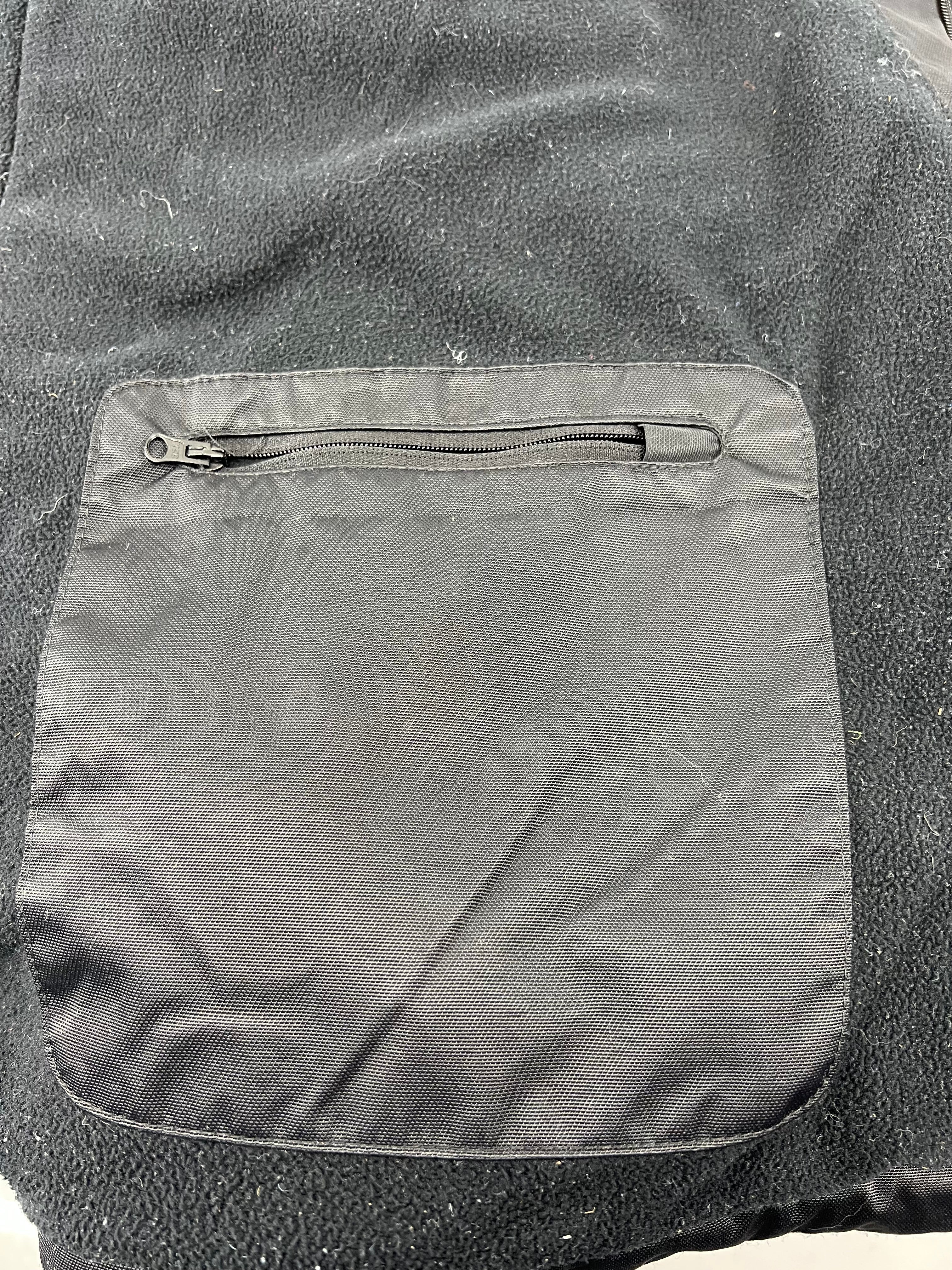 Inside fleece lining pocket with zipper on black jacket