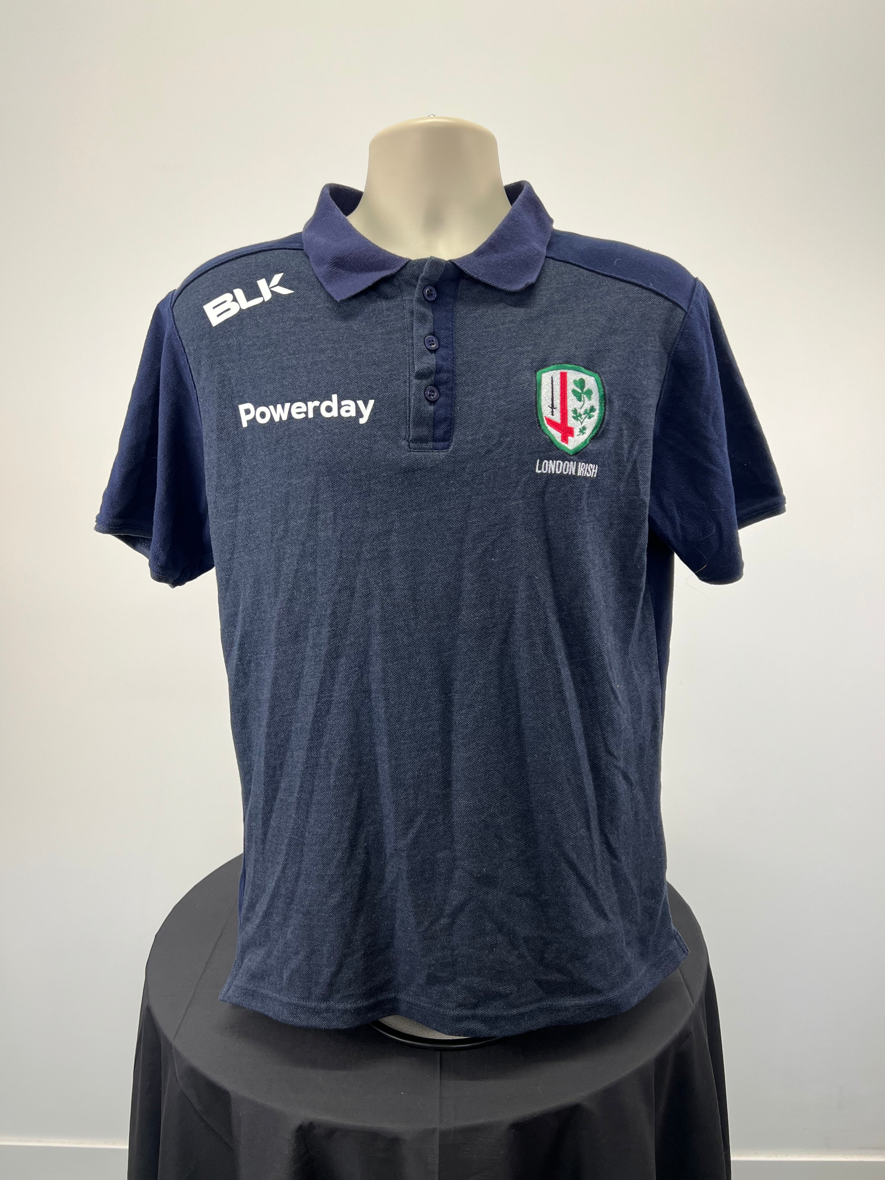 Front view of Men’s BLK London Irish rugby club navy blue polo top with club crest and sponsor logos