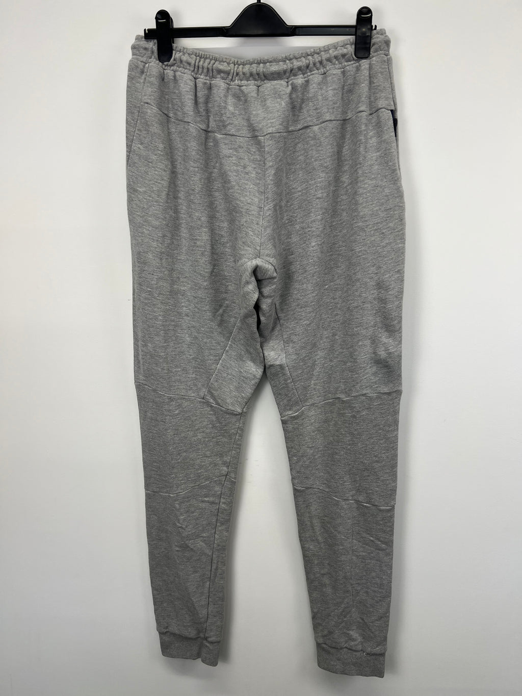 Rear view of Men’s grey BLK Exiles tracksuit trousers showing overall design