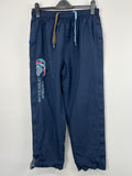 Front view of men's navy blue Canterbury of New Zealand tracksuit trousers hanging on hanger