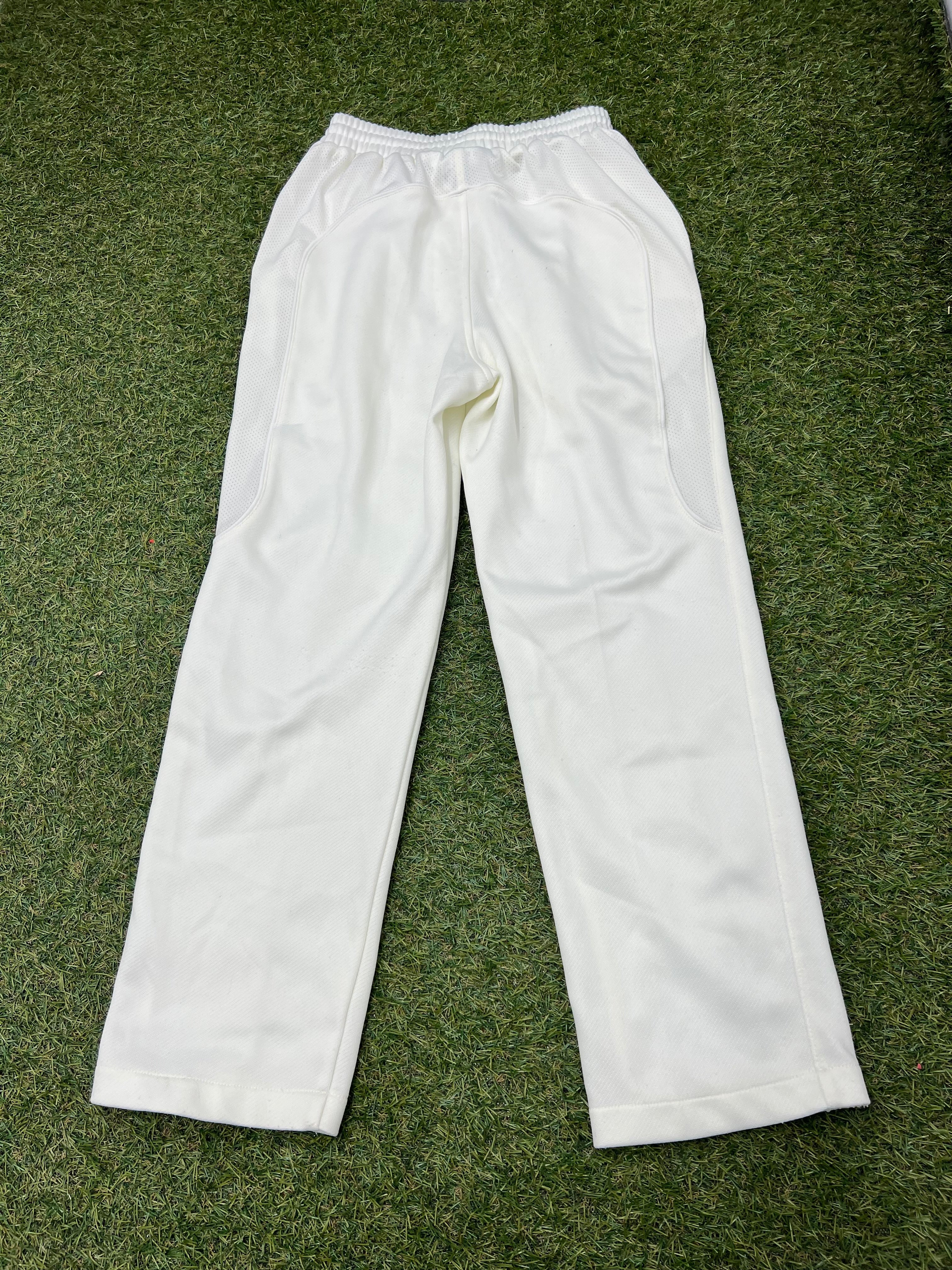 Back view of white Kids Salamander cricket trousers size S showing elastic waistband and pocket detail