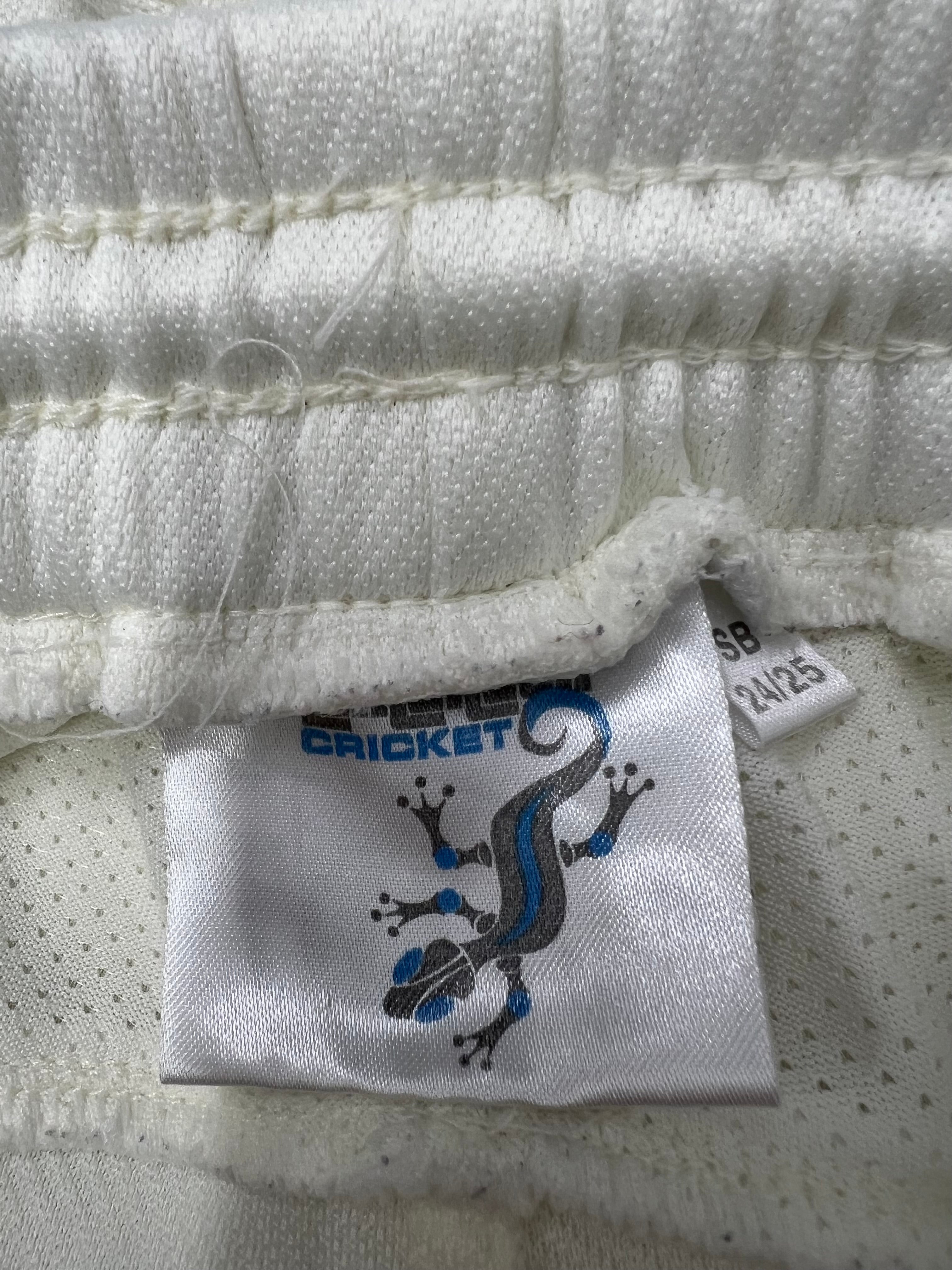 Close-up of Kids Salamander cricket trousers label inside waistband showing brand logo and size