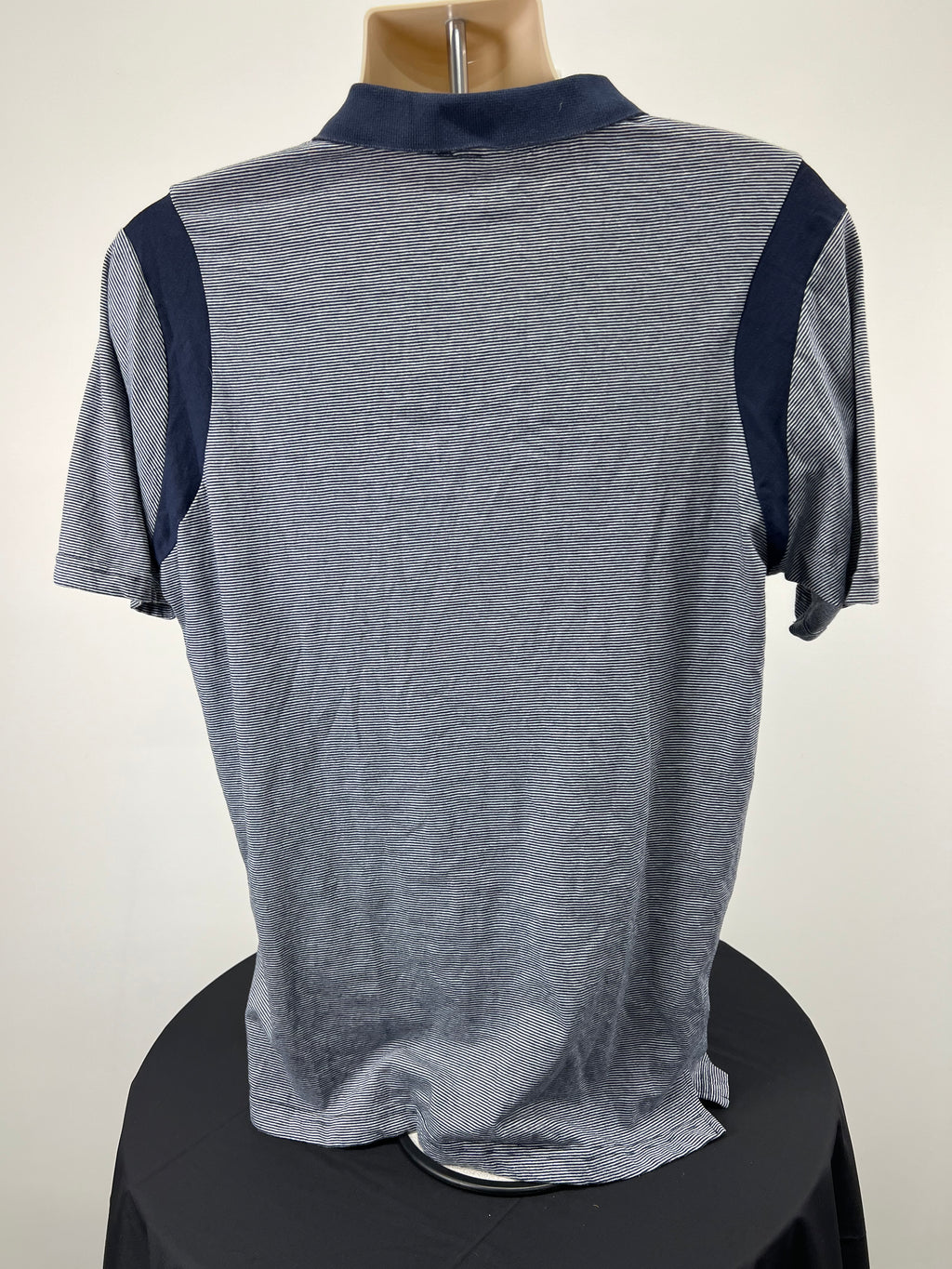 Back view of navy and white striped Men’s London Irish polo shirt with solid navy shoulder panels