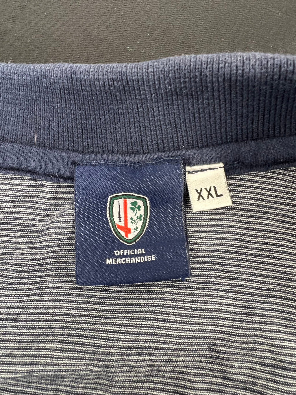 Close-up of the polo top label showing London Irish official merchandise and XXL size