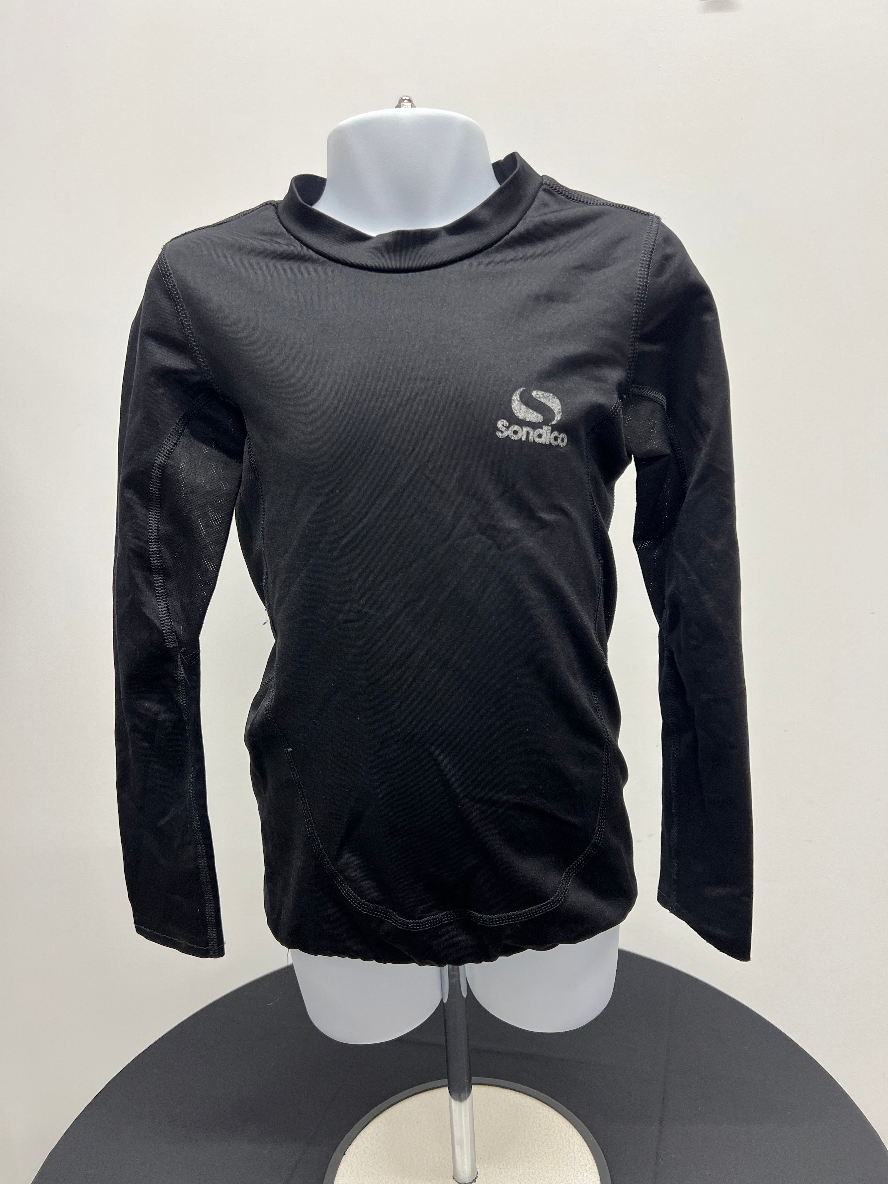 Front view of black long sleeve kids Sondico base layer top on mannequin