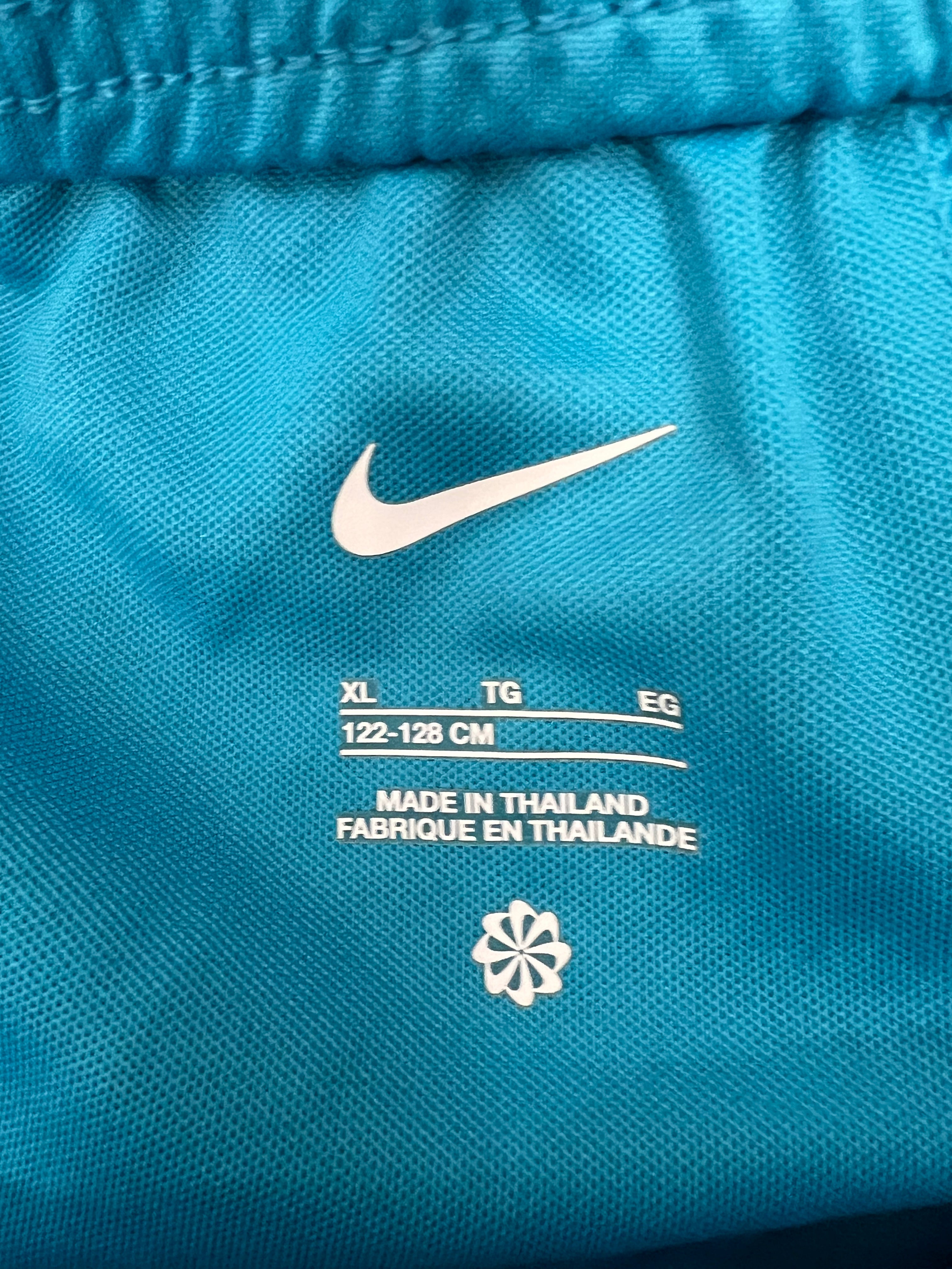 Close-up of inner label of kids Tottenham Hotspur FC blue shorts indicating size 122-128 cm and made in Thailand