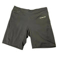 Front view of black women’s LA Gear cycling shorts laid flat on grass